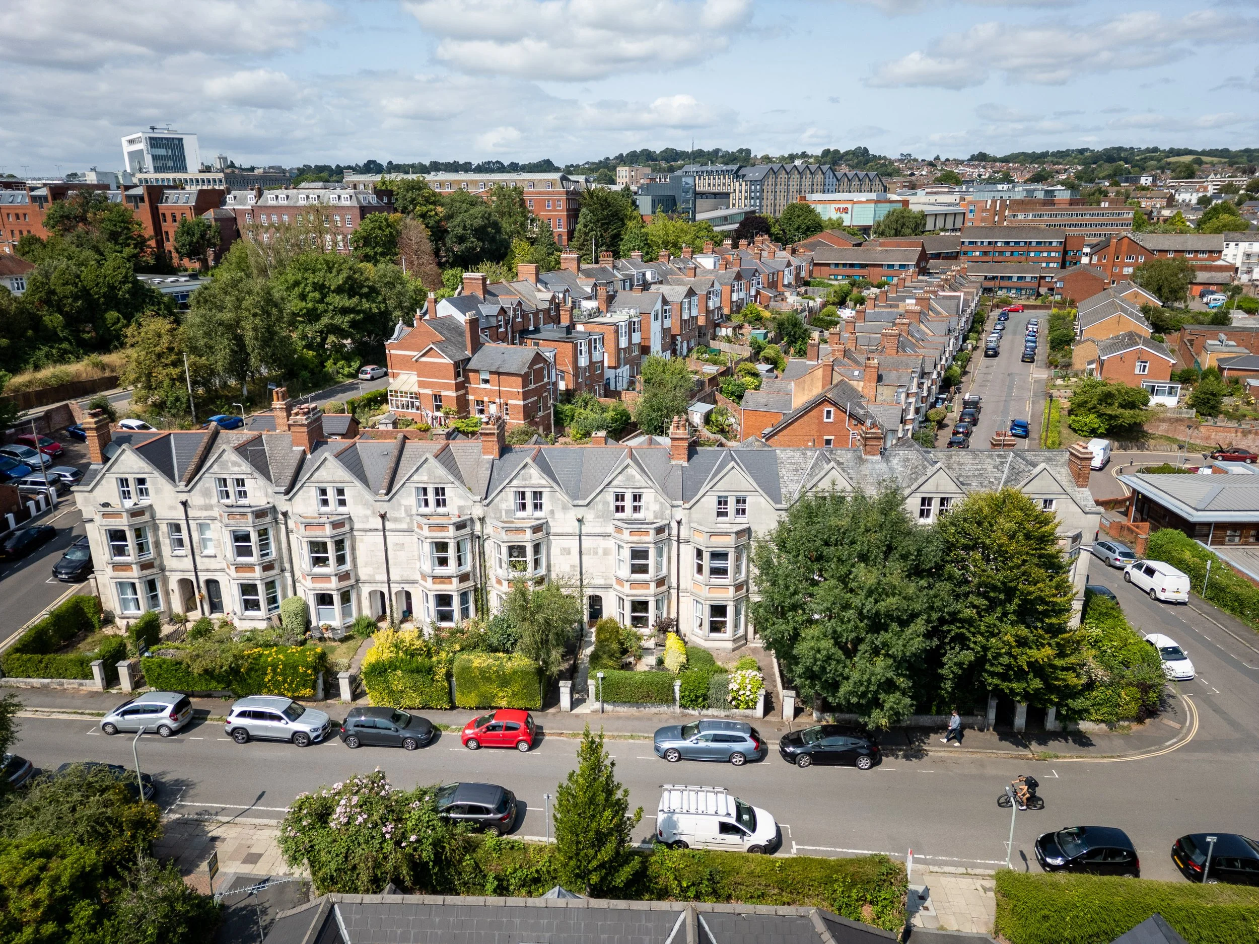 Drone photography of Exeter townhouses and residential streets with cars and rooftops