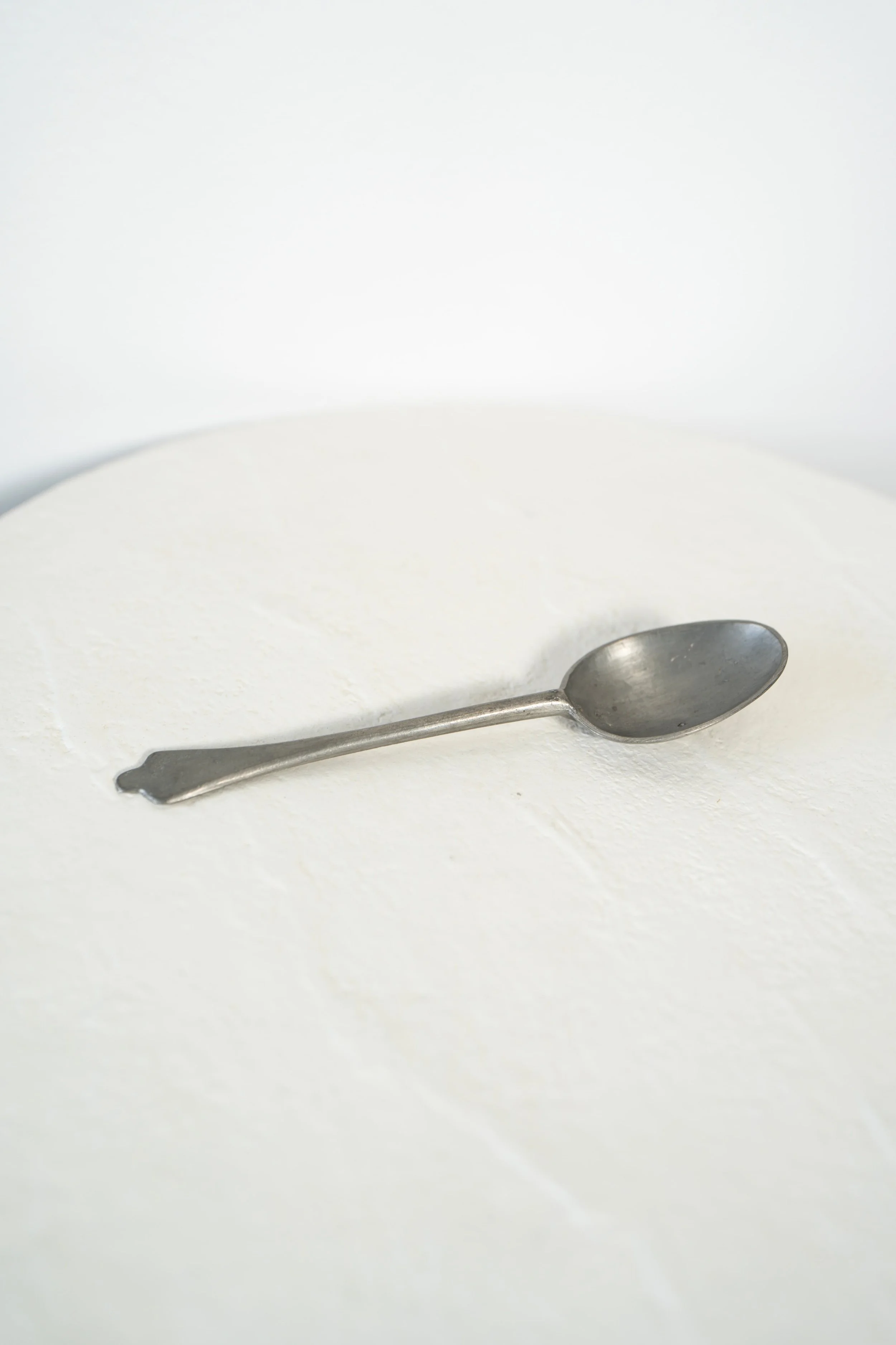Pewter Spoon on white table.jpeg