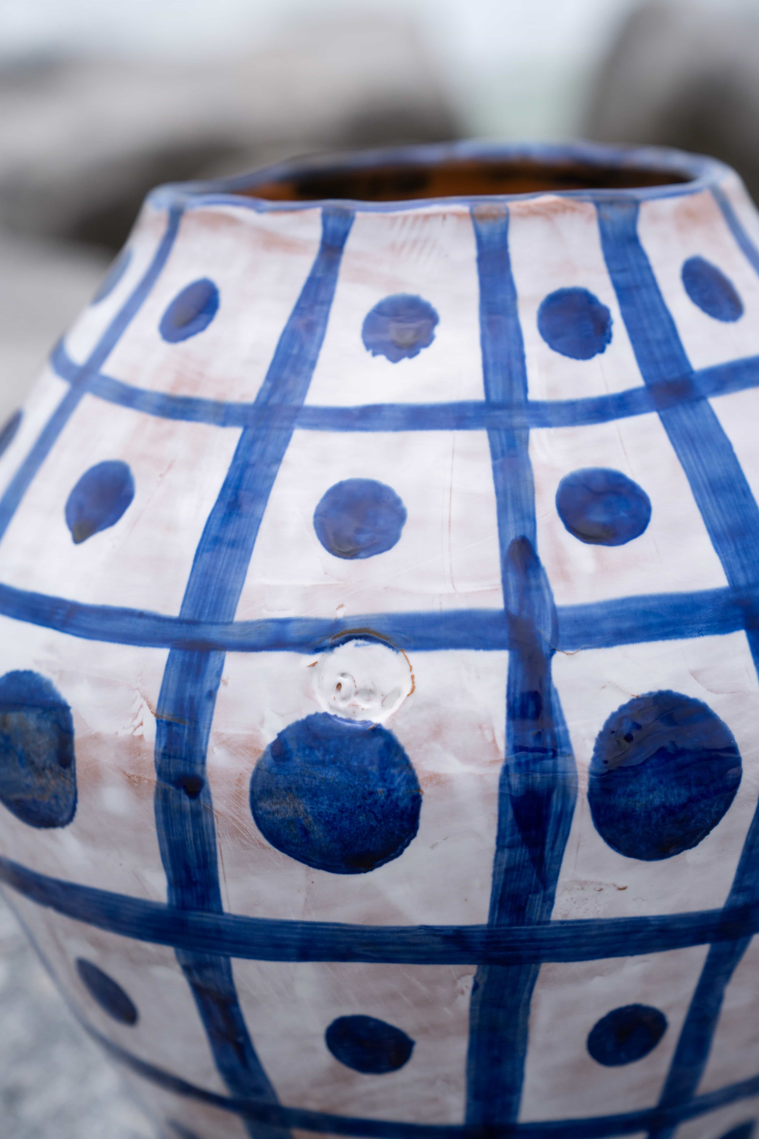 Close up of signed blue and white grid ceramic pot.jpeg