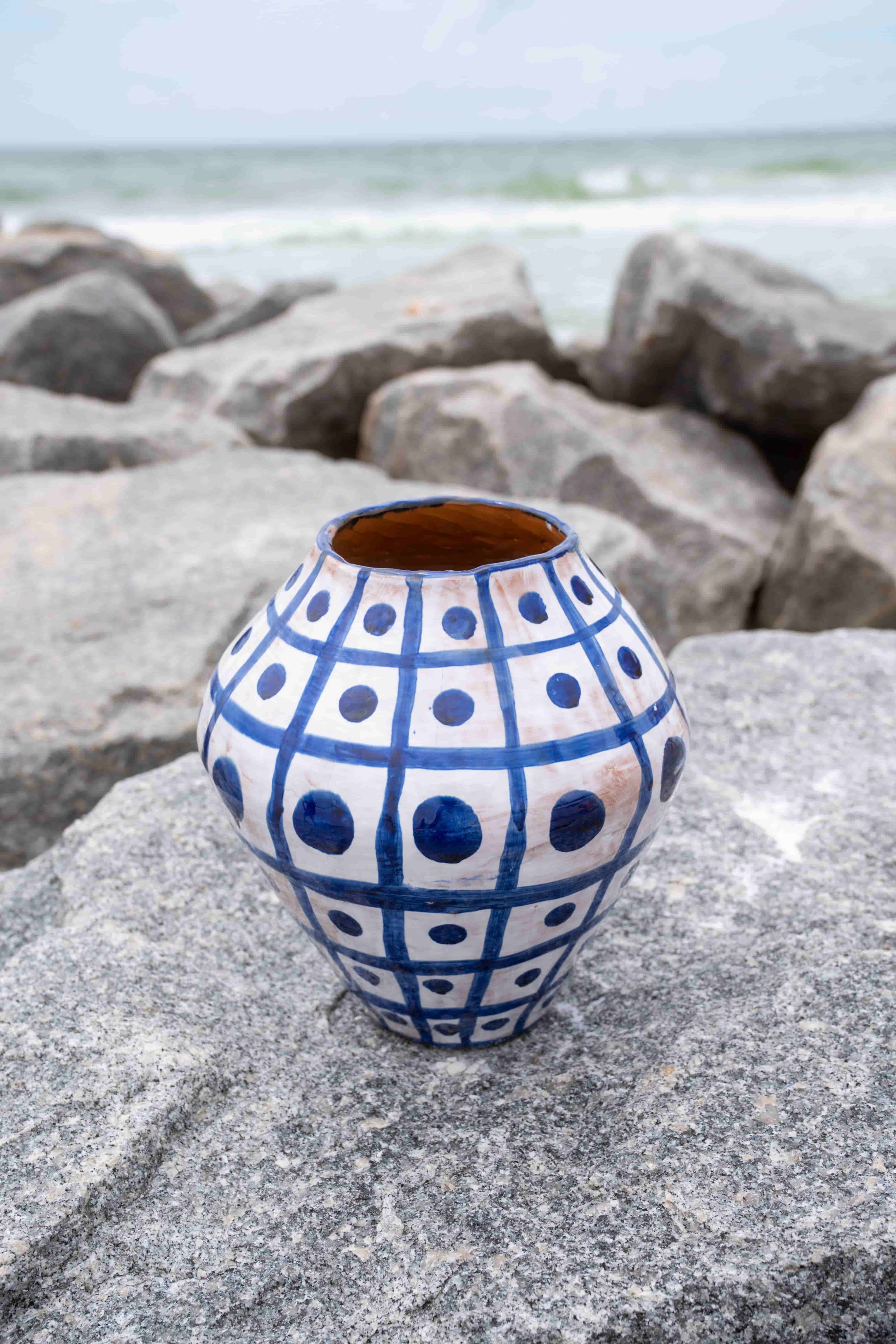 Blue and white grid ceramic pot by the sea.jpeg