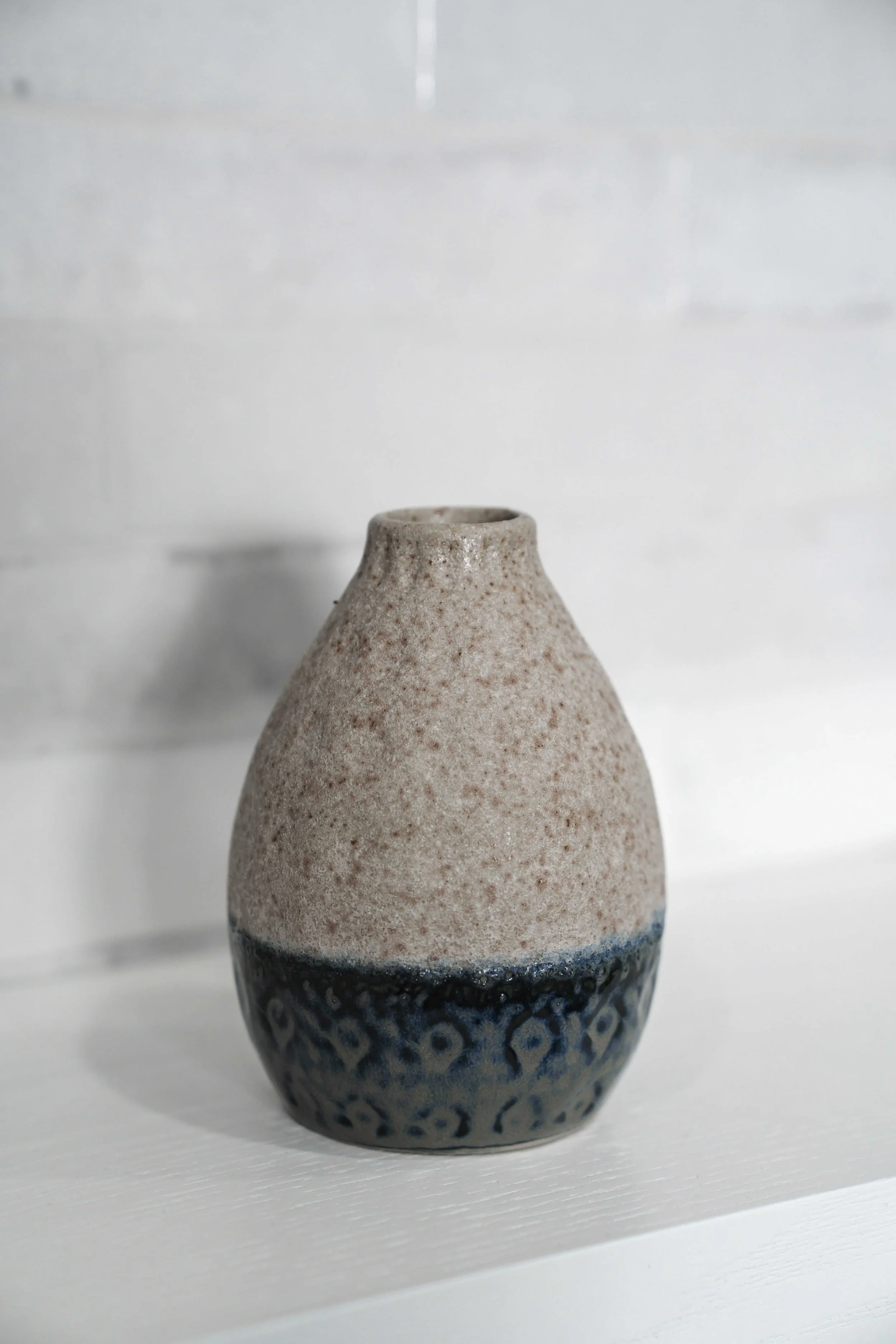 Speckled stone ware vase with blue glazed bottom.jpeg