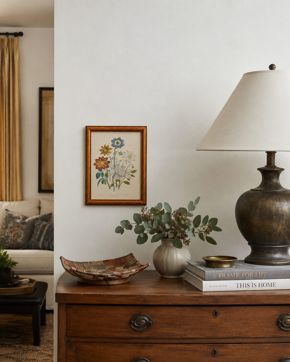 Framed floral print over an entry table.png