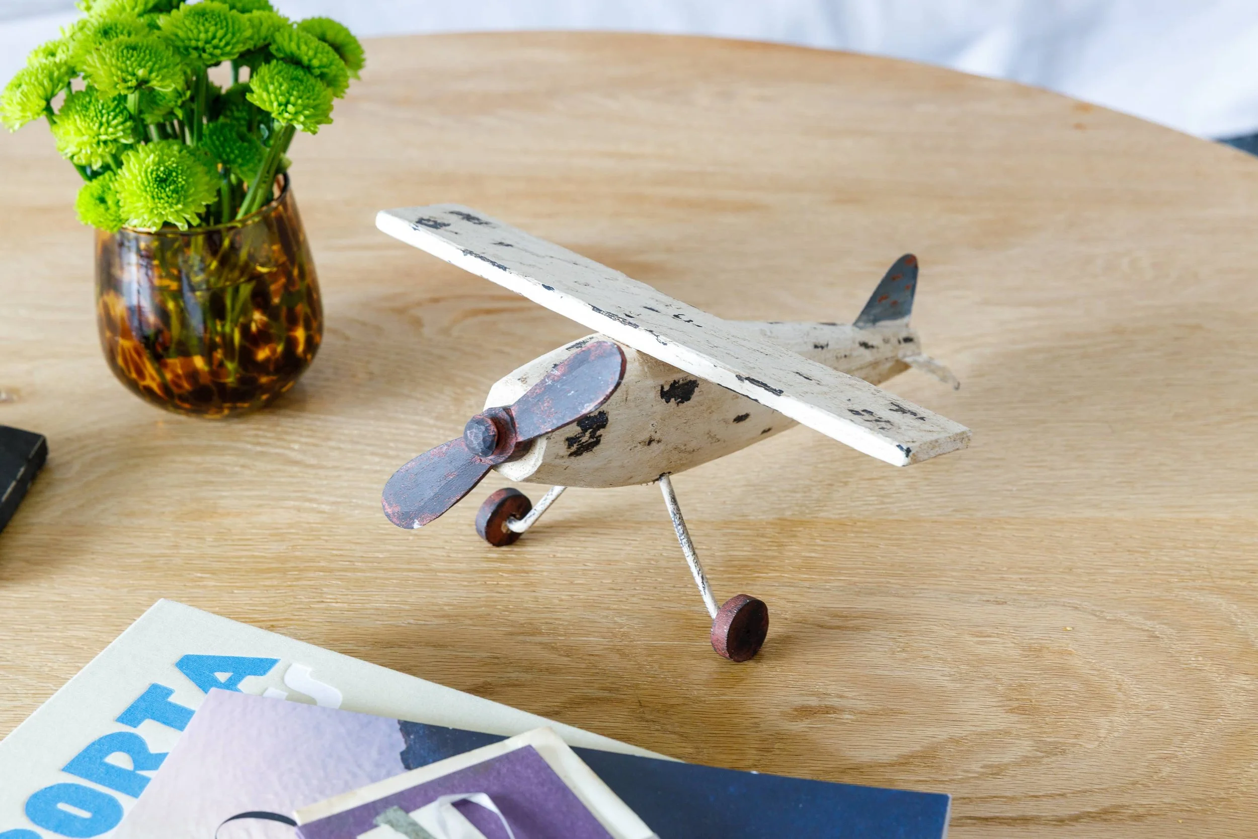 Vintage wooden airplane on table top closeup.jpeg