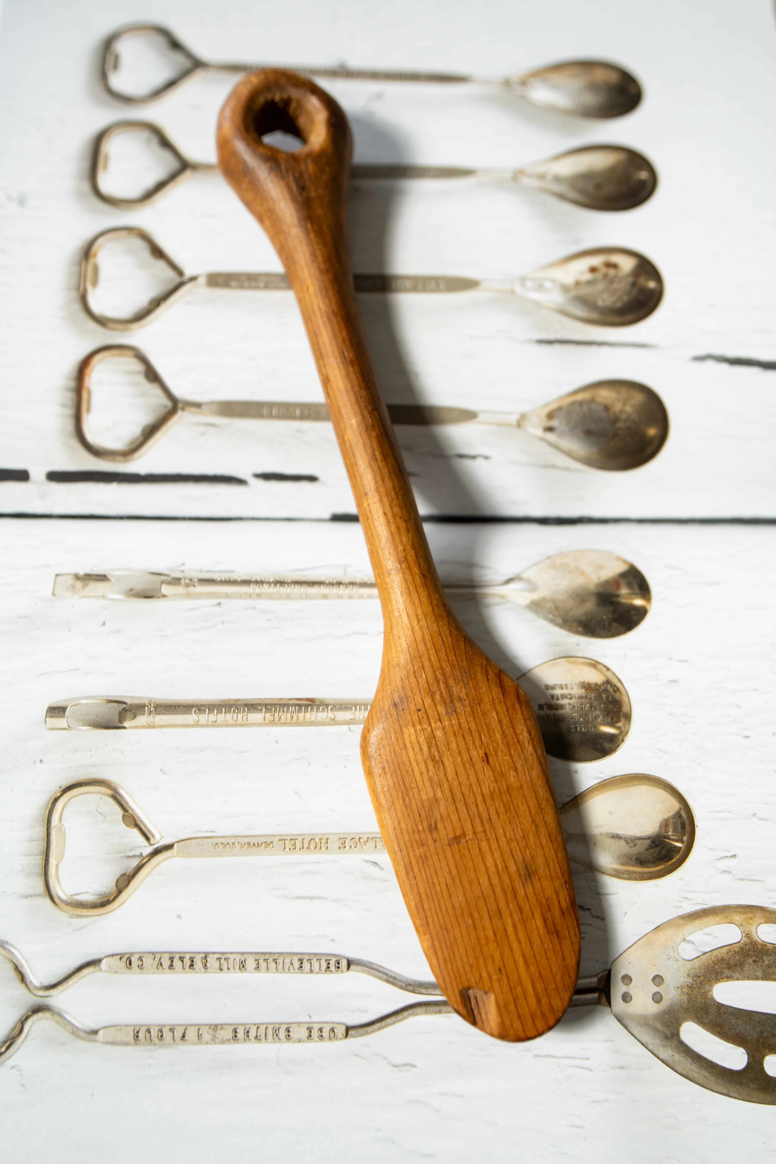 Antique Wooden Spoon, on book with silver spoons.jpeg