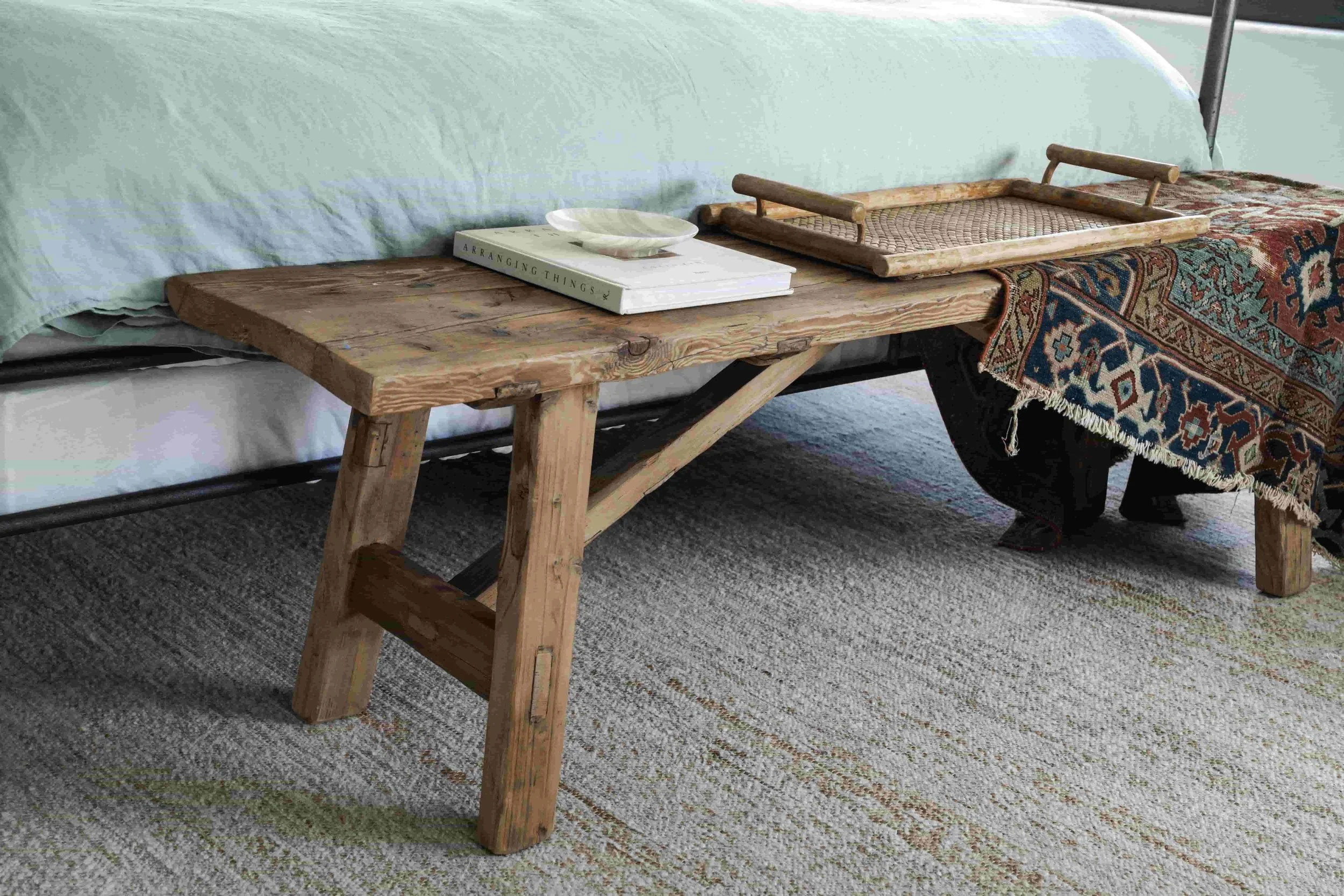 Antique bench at the foot of a bed.jpg