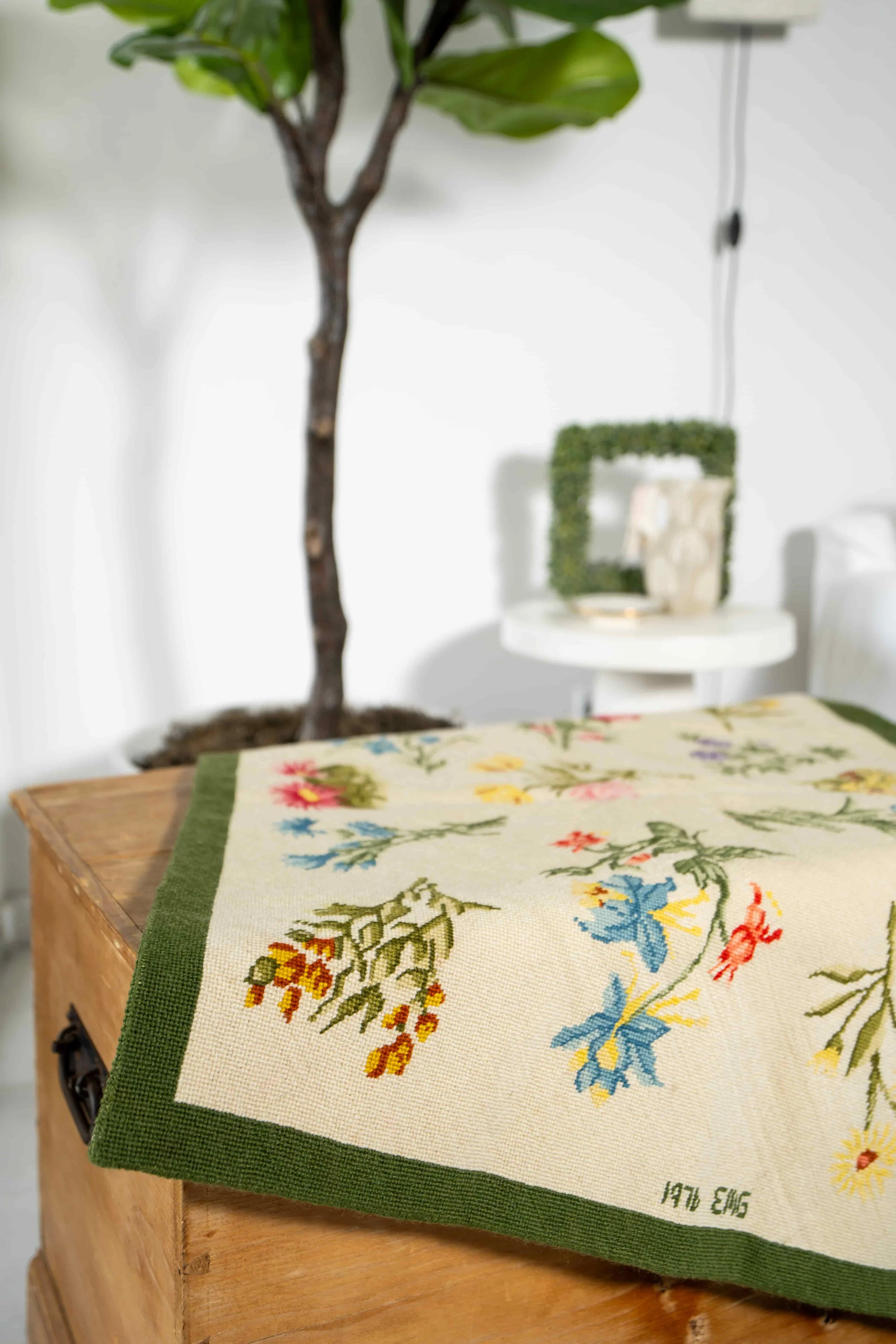 Needle point rug on pine chest.jpeg