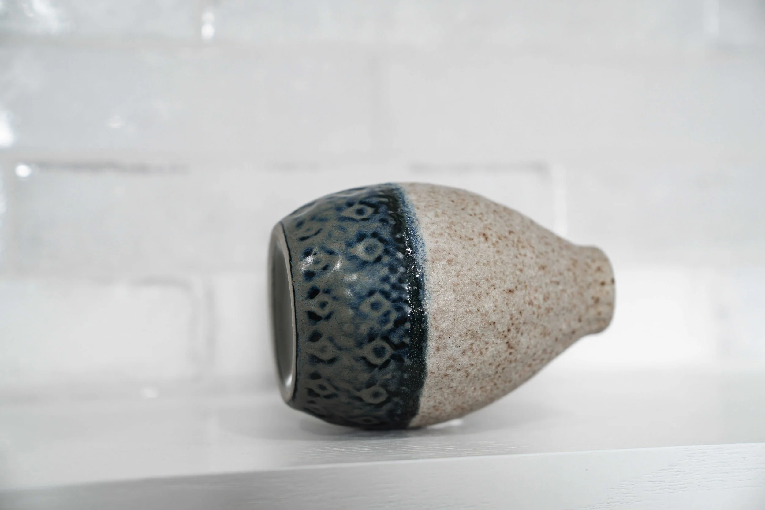 Close up of stoneware vase on its side.jpeg