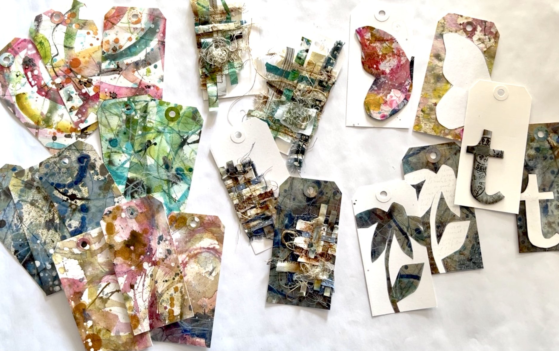 Mixed Media Artist Tracey Wozniak makes mixed media upcycled tags. She includes messy imperfect watercolor art, fussycut silhouette drawings, and scrap textiles