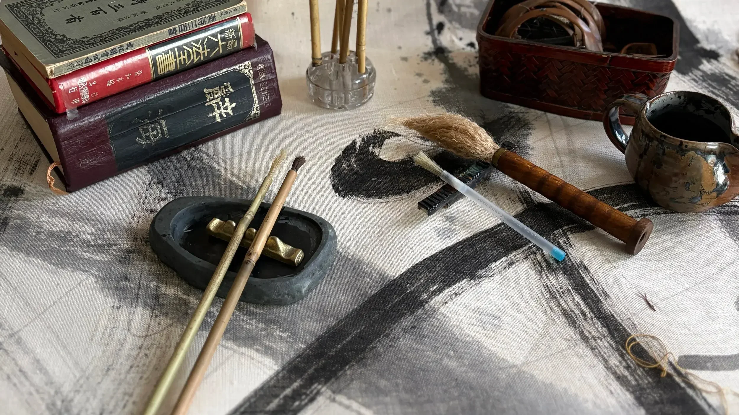 Various paint supplies and books splayed out on a table
