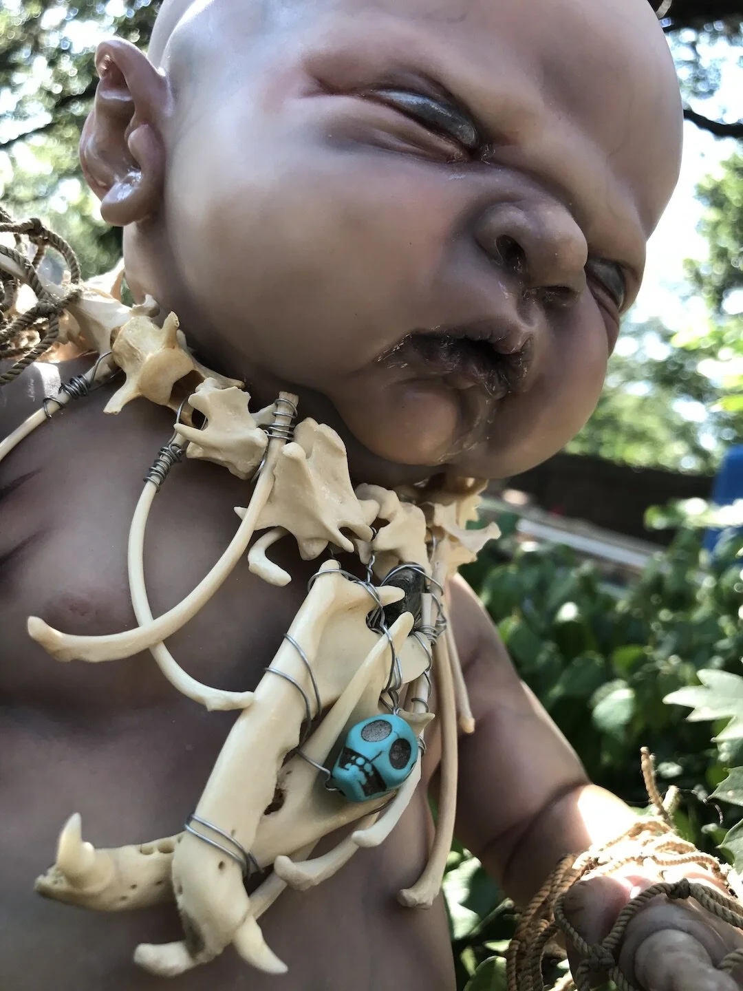 This grumpy little swamp baby was created by Kirsten Bjøre using the Maggie sculpt by Cindy Musgrove. Kirsten also made his bone necklace and costume.