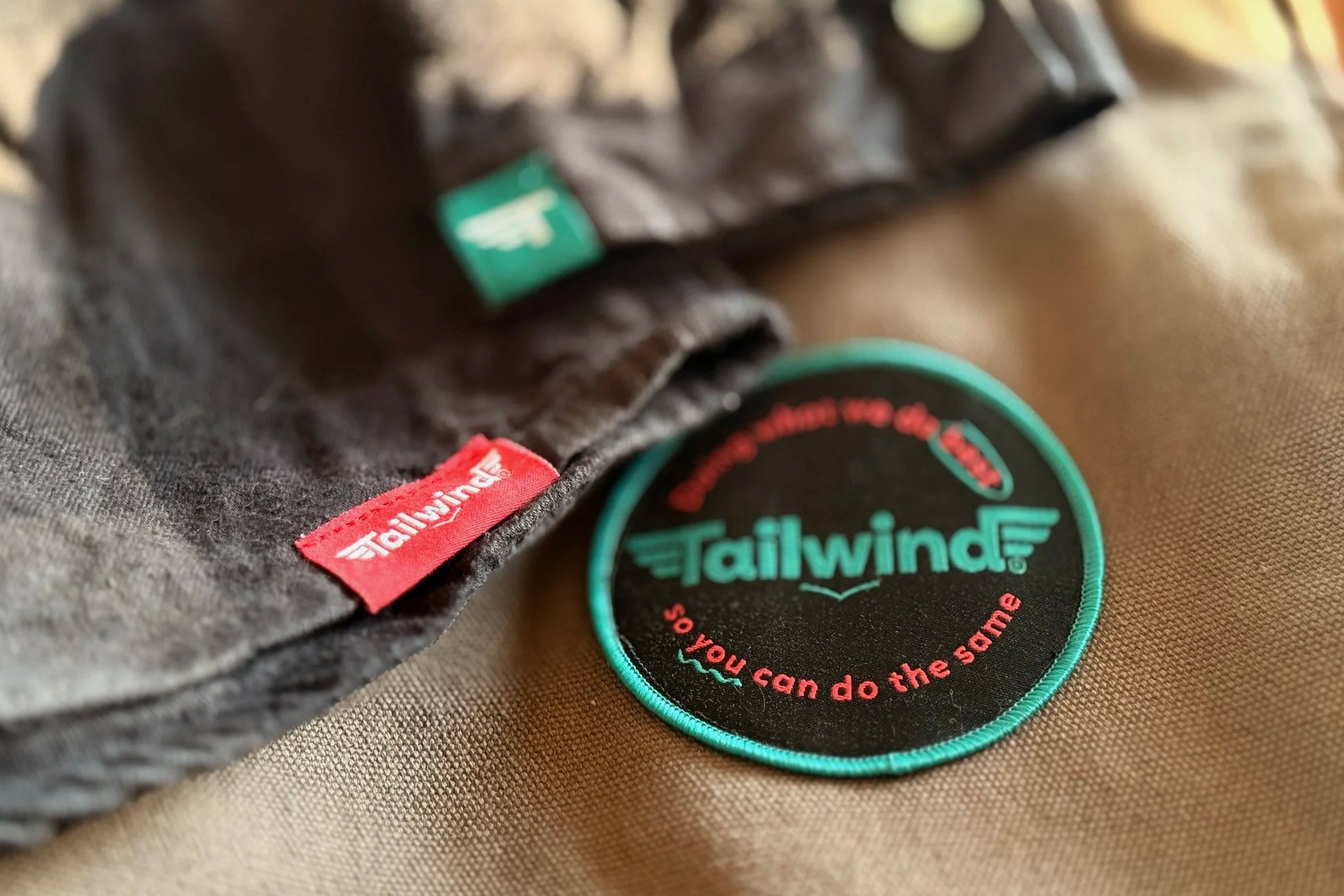 Custom pip labels and badges for Tailwind really elevate our branded apparel to the next level!