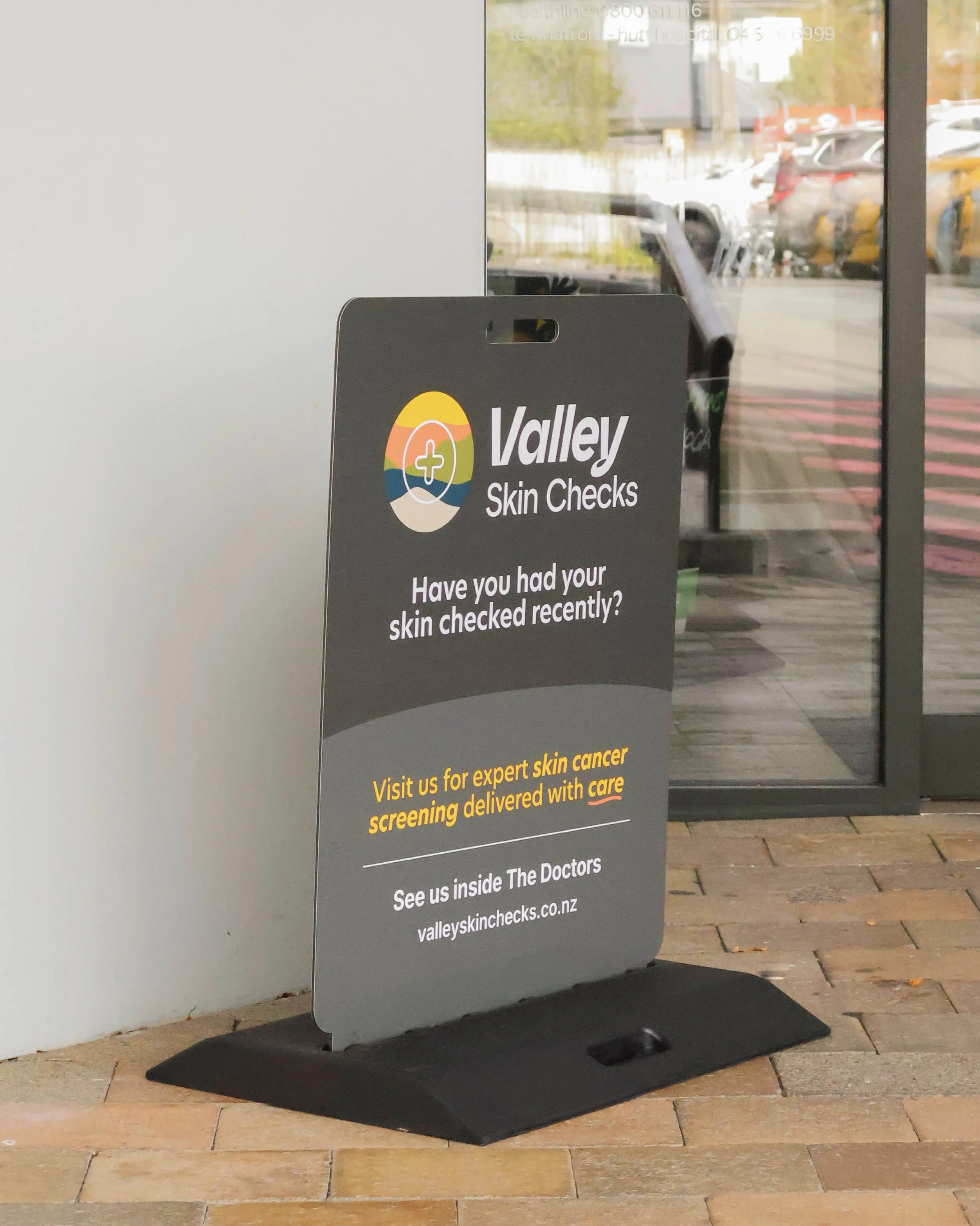 Clean Footpath sign design for Valley Skin Checks, located in Silverstream Doctors 