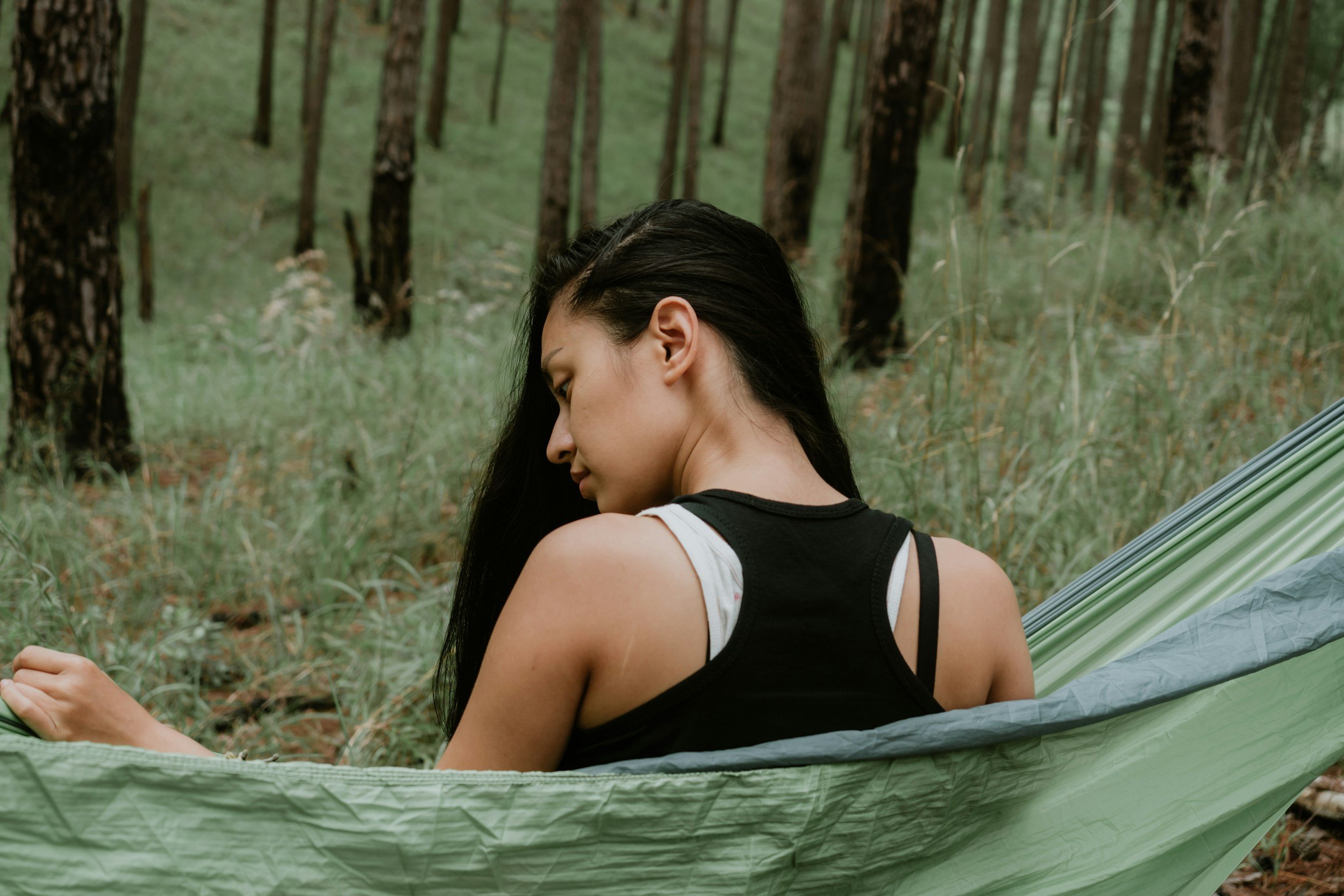 Woman relaxing on hammock in nature