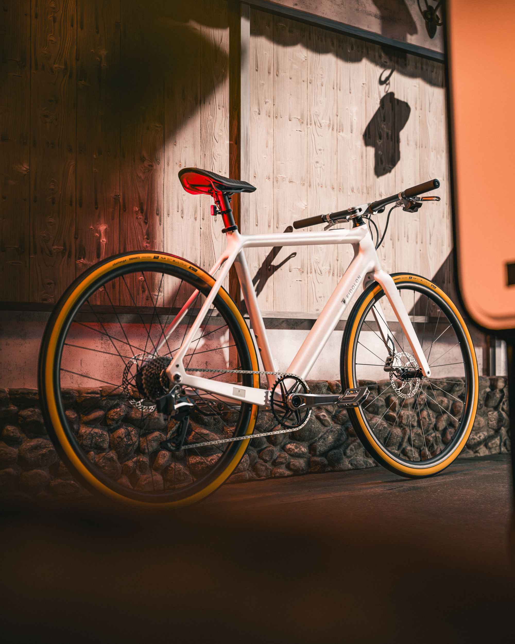 EIDOLON eBike in white leaning against a wooden wall.