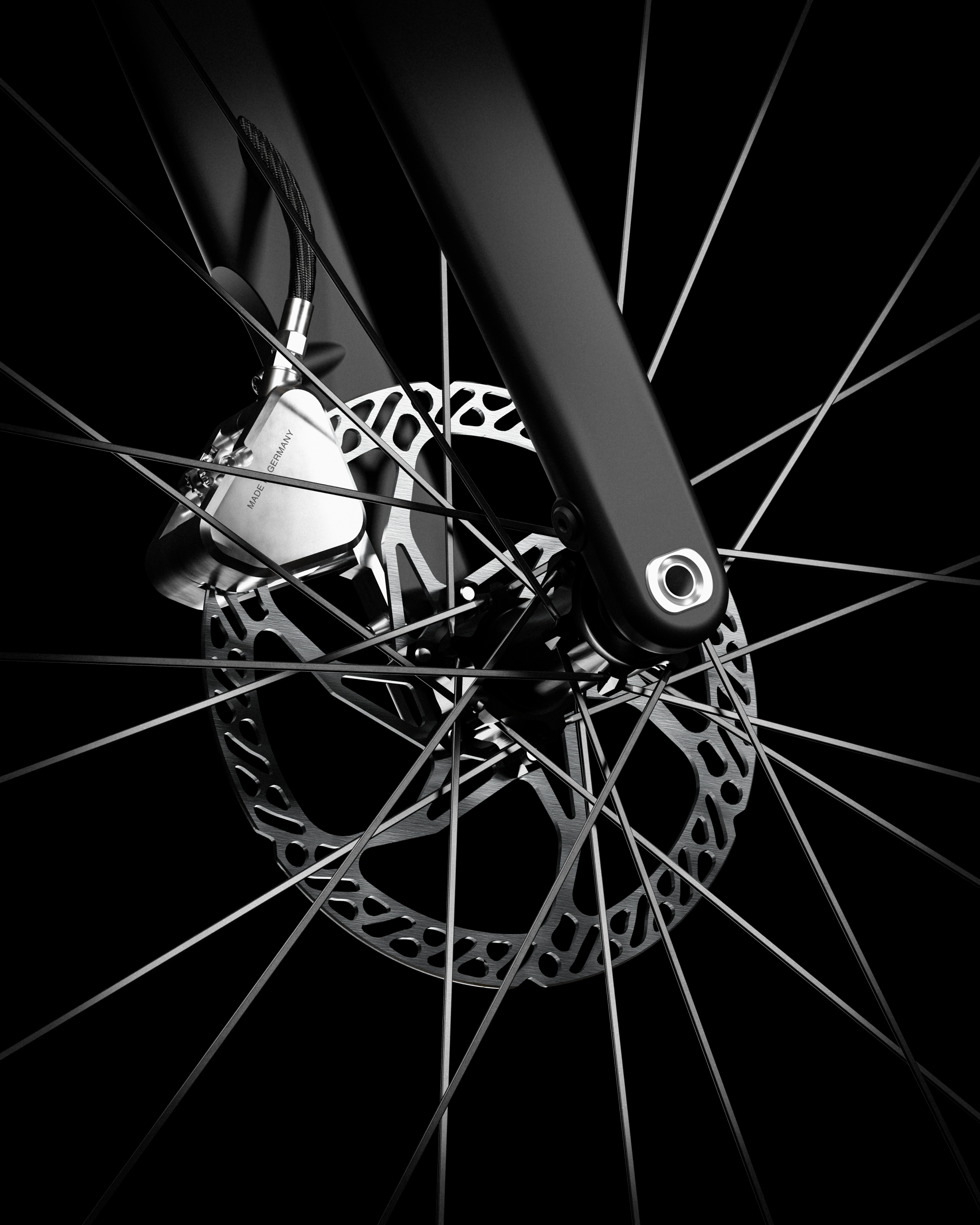 Close-up of Ponomarets front brake calliper and rotor against a black background.