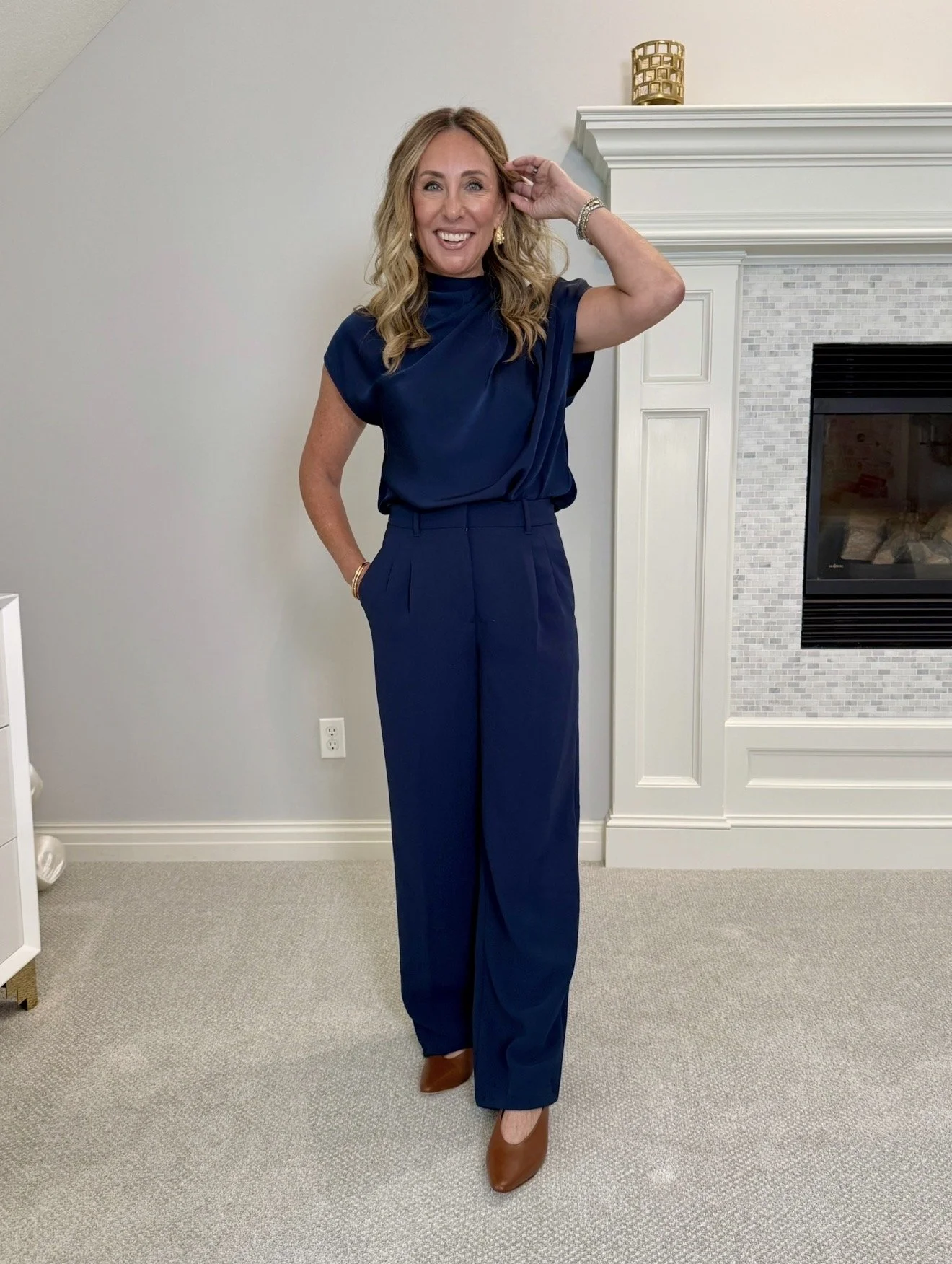 Hallie in the Aritzia black mockneck top, a look for less for the TWP version, with navy trousers