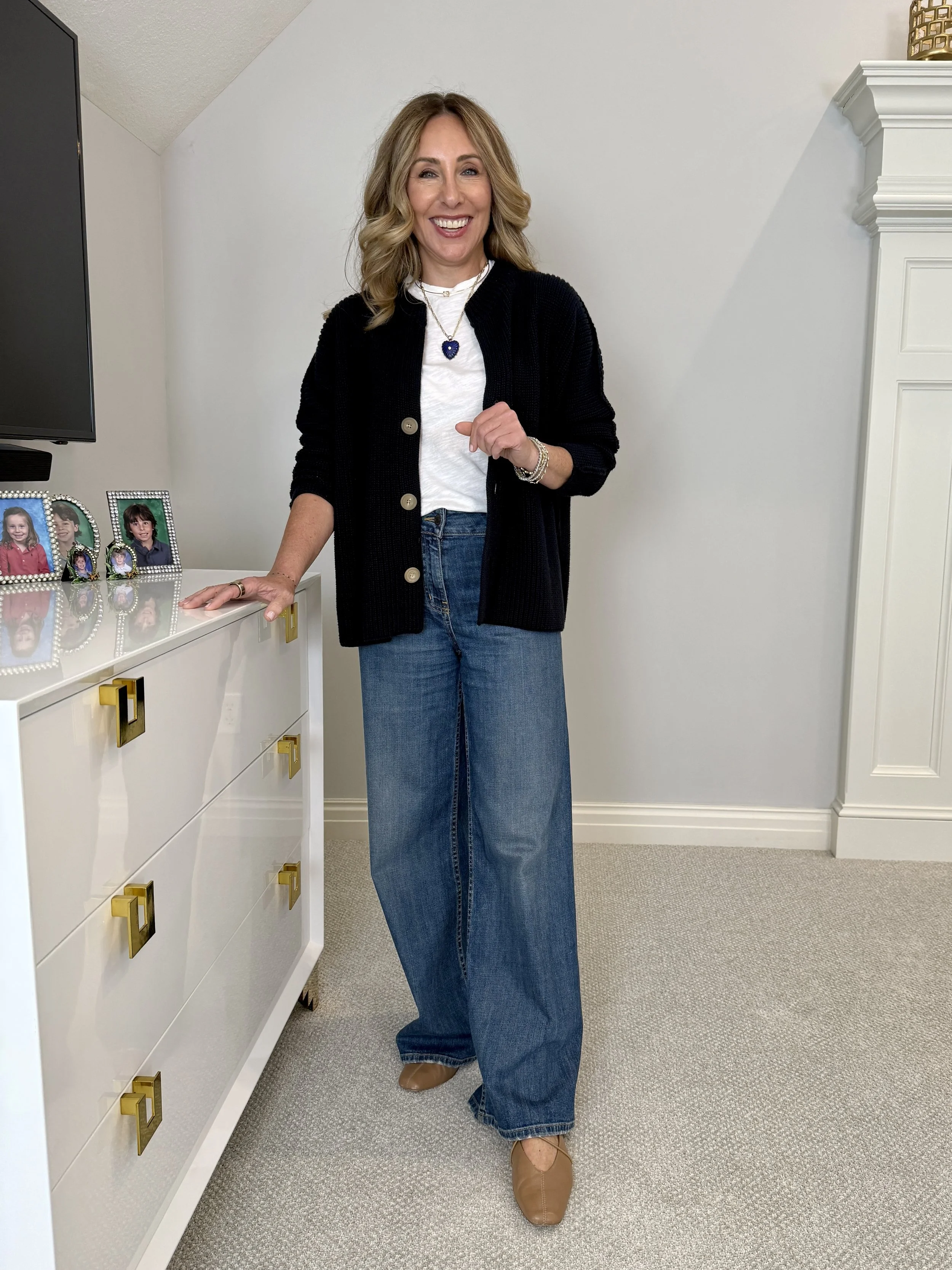 Hallie in the Frank & Eileen Montecito cardigan in navy over a white tee with wide leg jeans