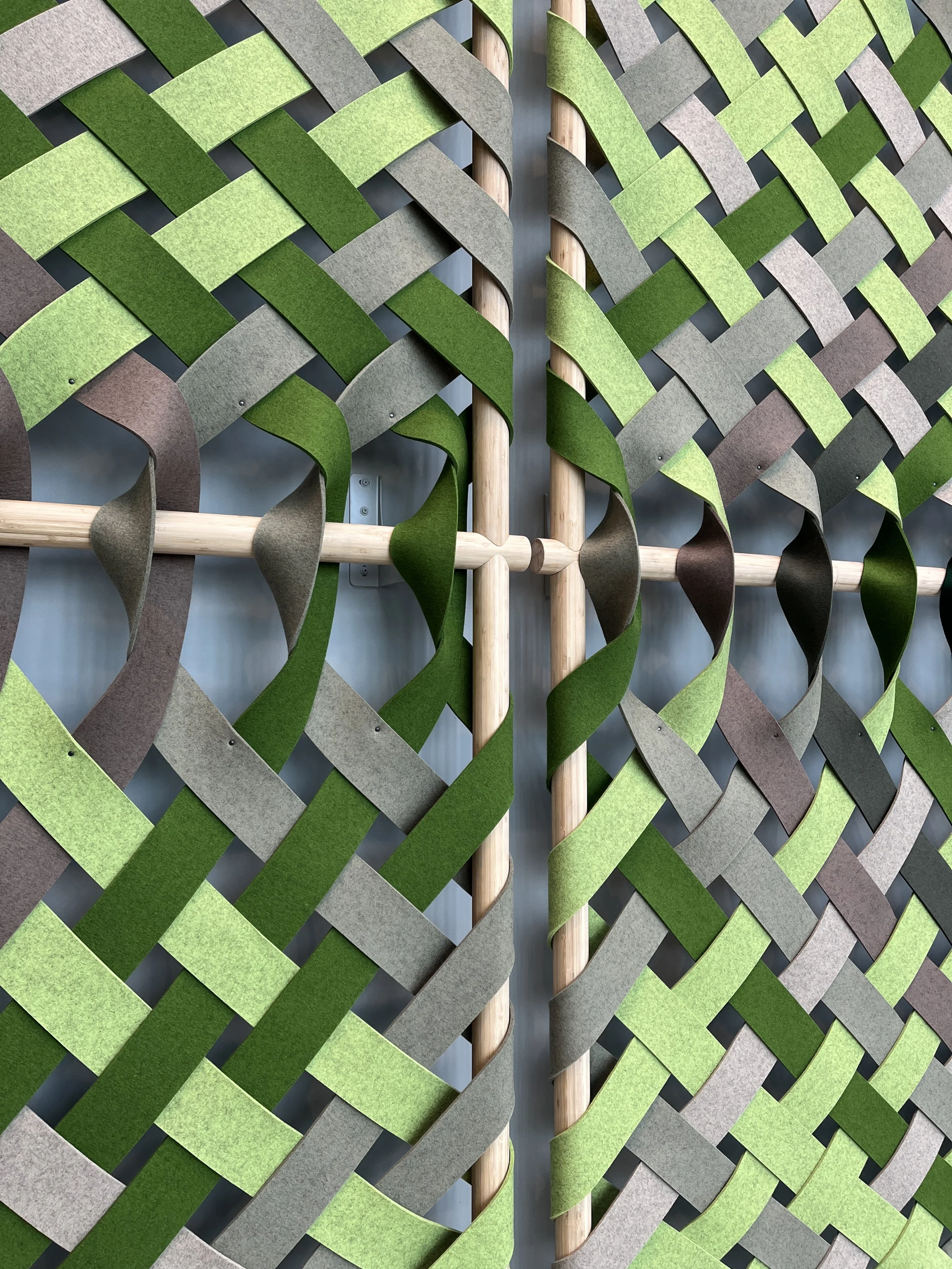 Wool strips interweaving around the bamboo frame.