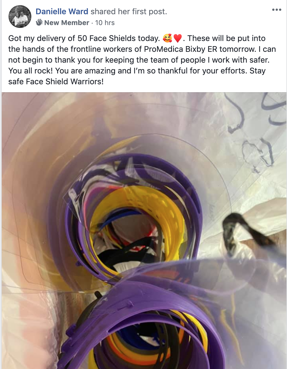 Several colorful face shields rolled up and stacked in a clear plastic bag.