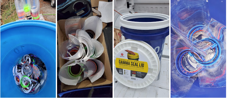 A collection of plastic beverage bottles, crushed and empty, in a blue recycling bin, along with a box of plastic lids, a bucket with a gamma seal lid, and a pile of crumpled plastic bottles.