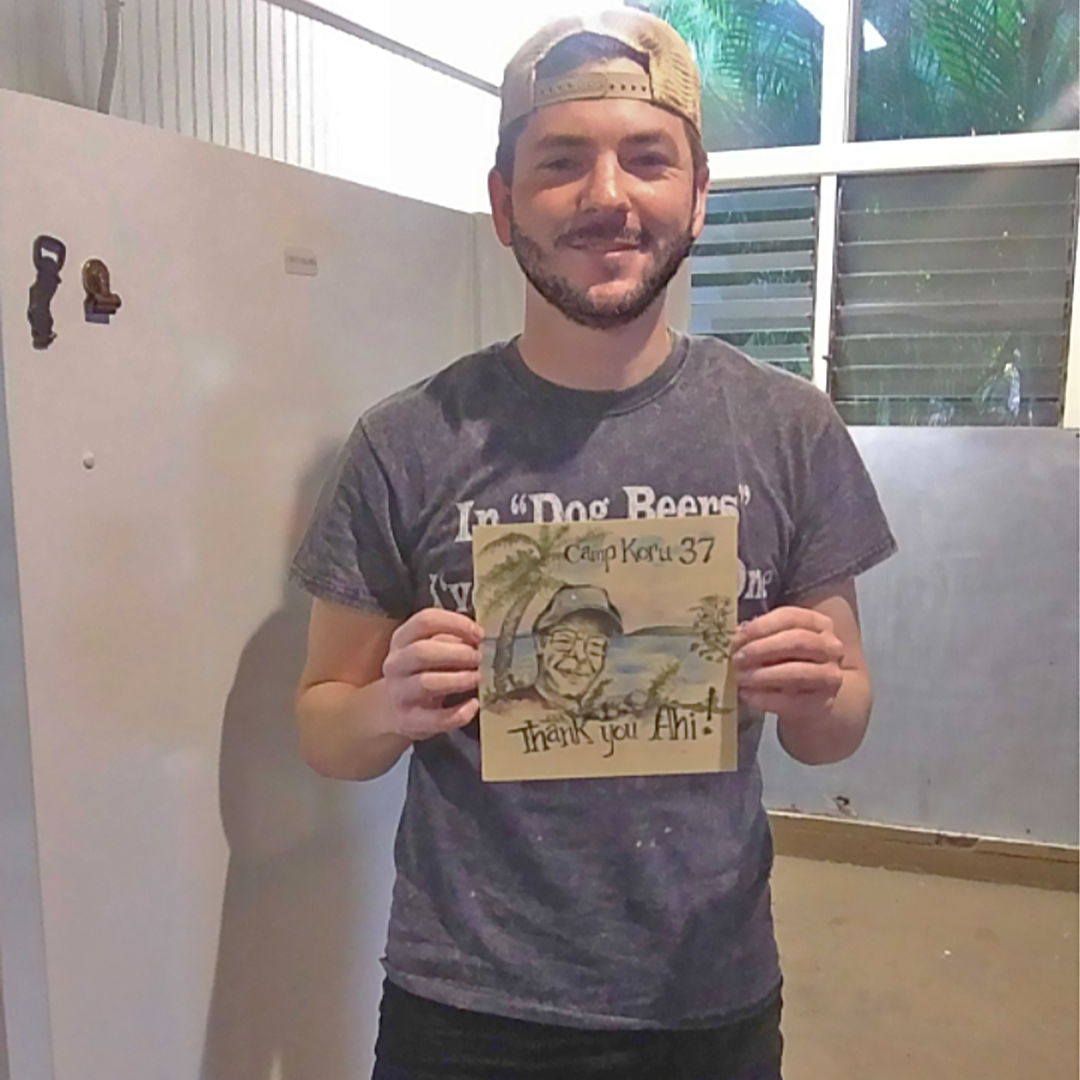 Calm holding a painting he made at Camp.