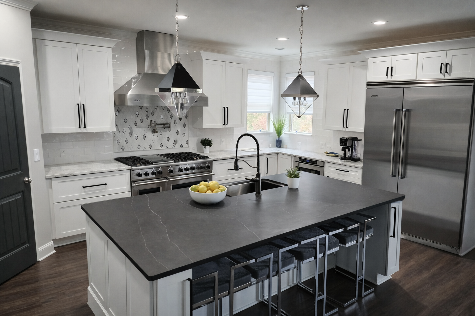 White kitchen design with dark island, stainless steel appliances, and mosaic backsplash by Welcome Home Interiors & Design, Buford GA