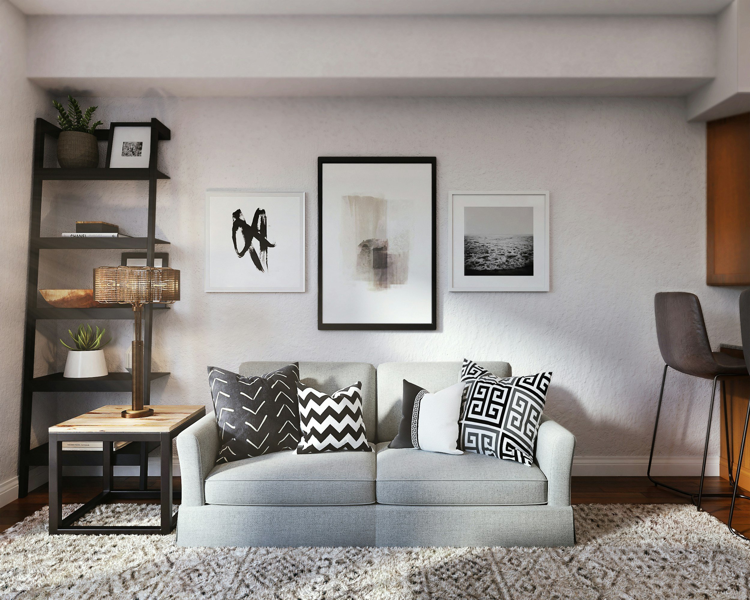 Neutral living room with custom styling, black and white artwork, textured pillows, and soft layered decor