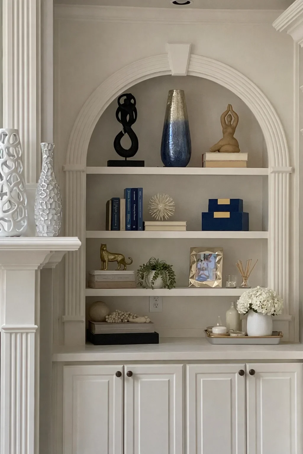 Styled built-in shelving and cabinetry detail in a soft neutral interior, representing a thoughtful interior design direction.