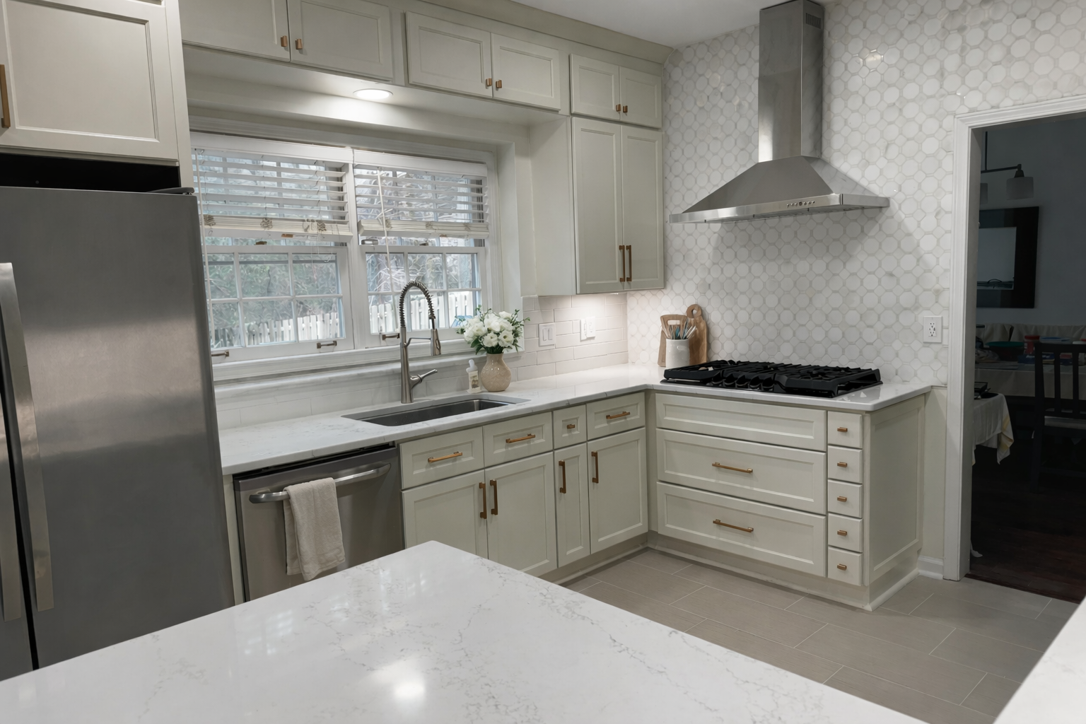 Full kitchen remodel with sage green cabinetry, brass hardware, circle tile backsplash, and quartz countertops designed by Welcome Home Interiors in Northeast Atlanta Georgia