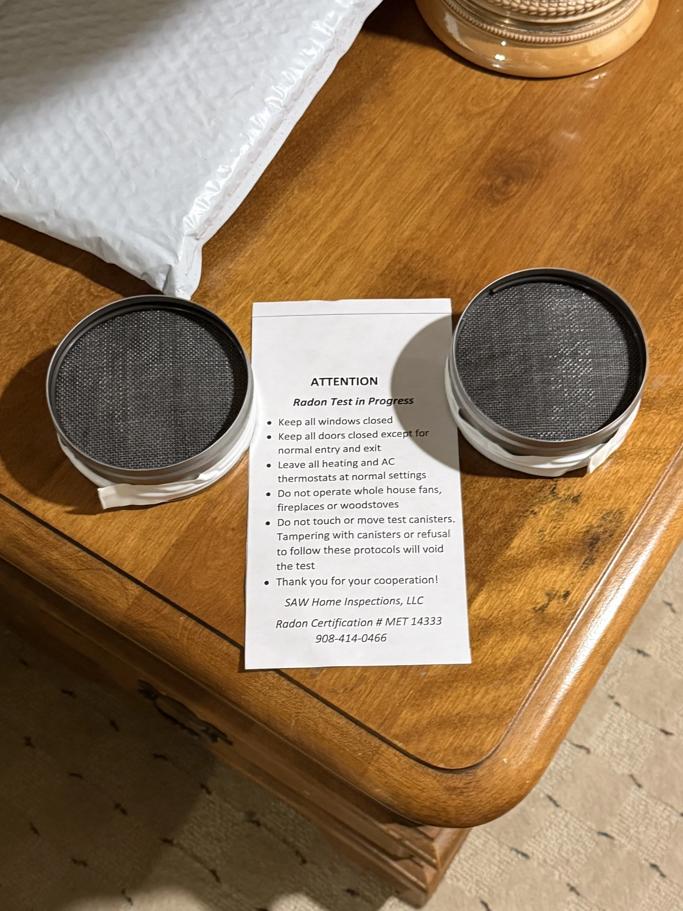 Charcoal radon test canisters placed in basement during professional radon testing