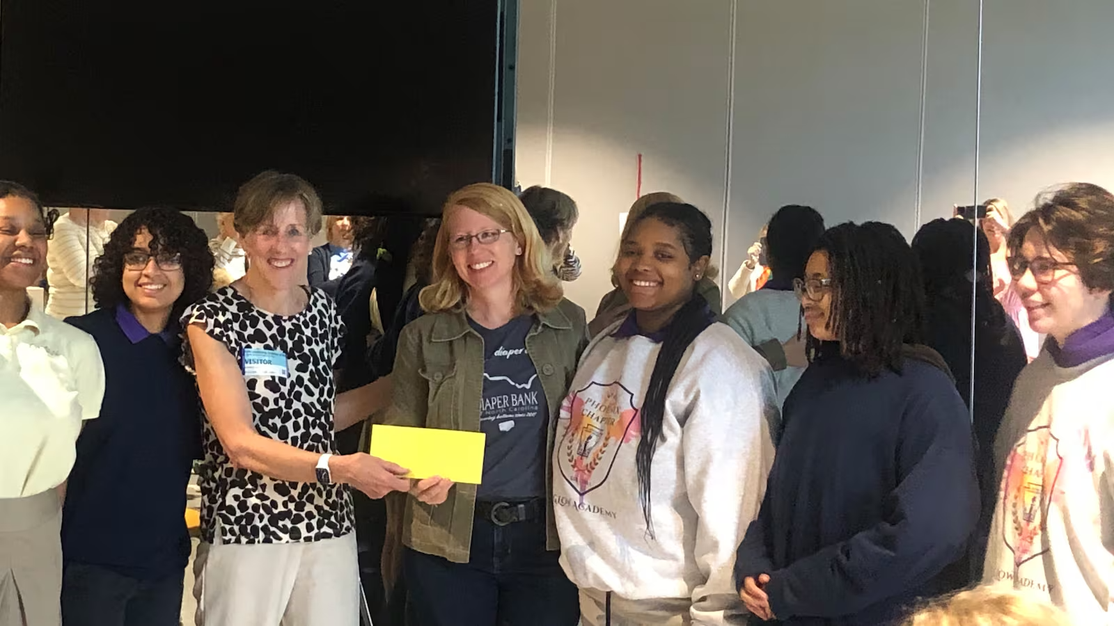 Six GLOW students award $1,000 grant to Diaper Bank of North Carolina