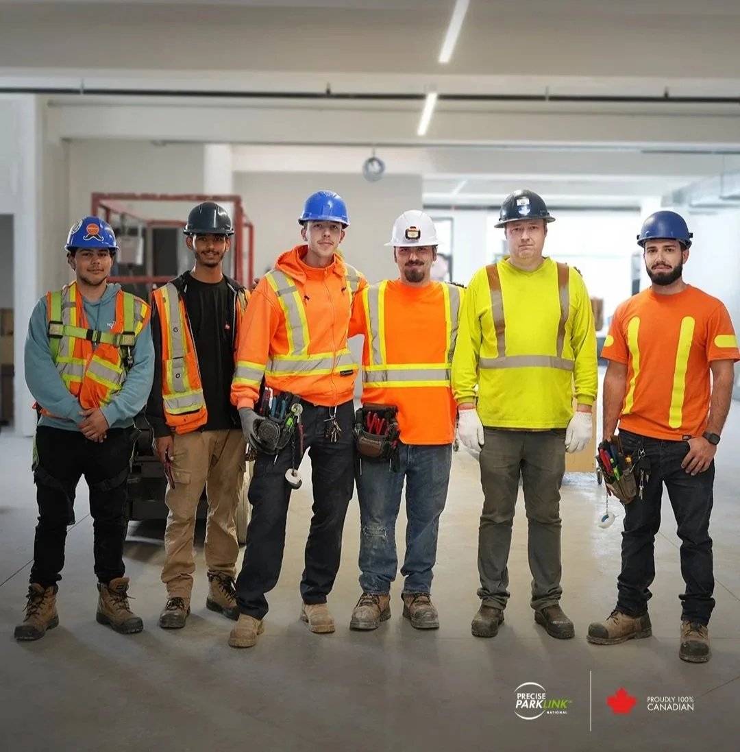A group of Precise ParkLink employees wearing construction gear 