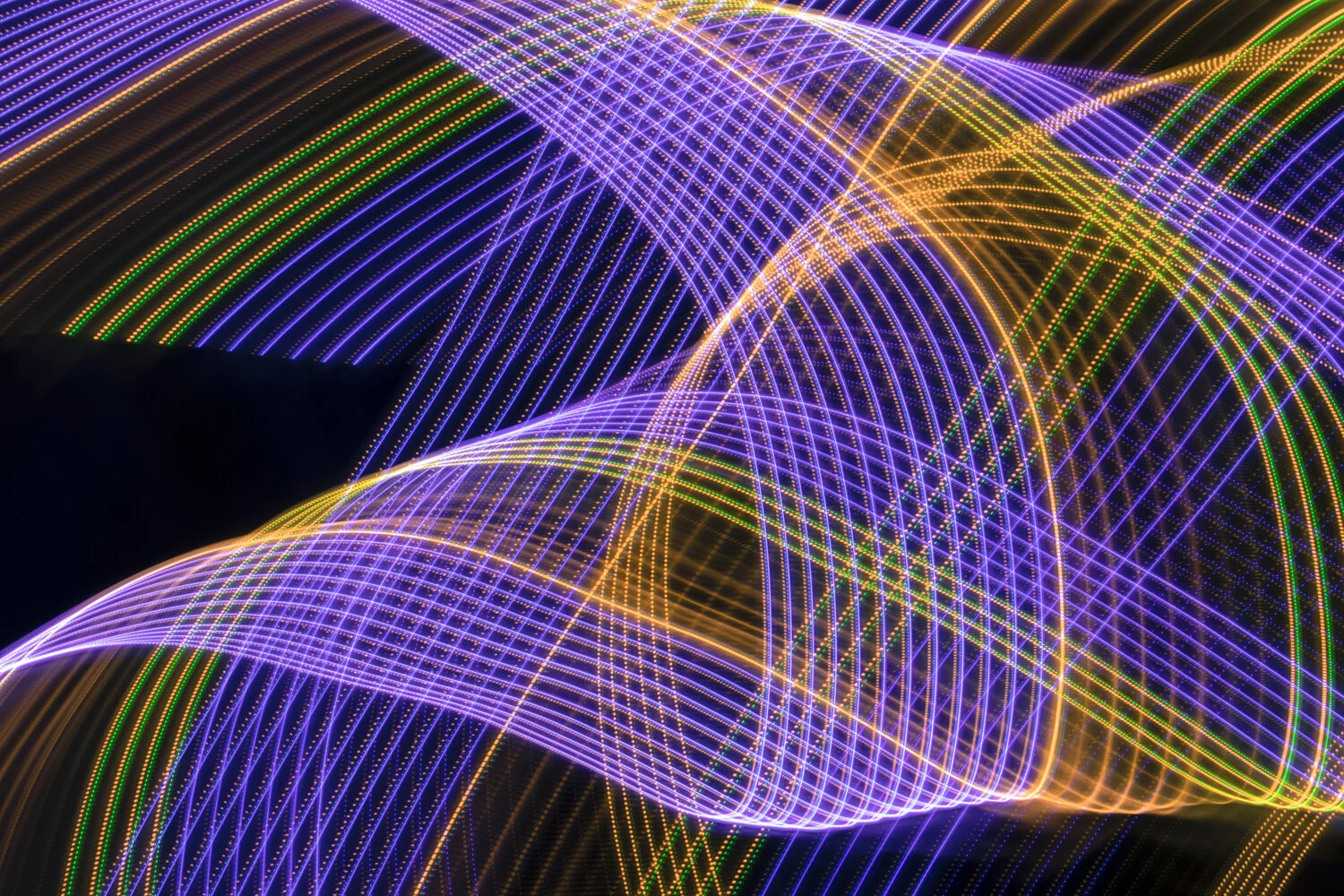 Colorful LED light streaks forming abstract wave patterns against a dark background.