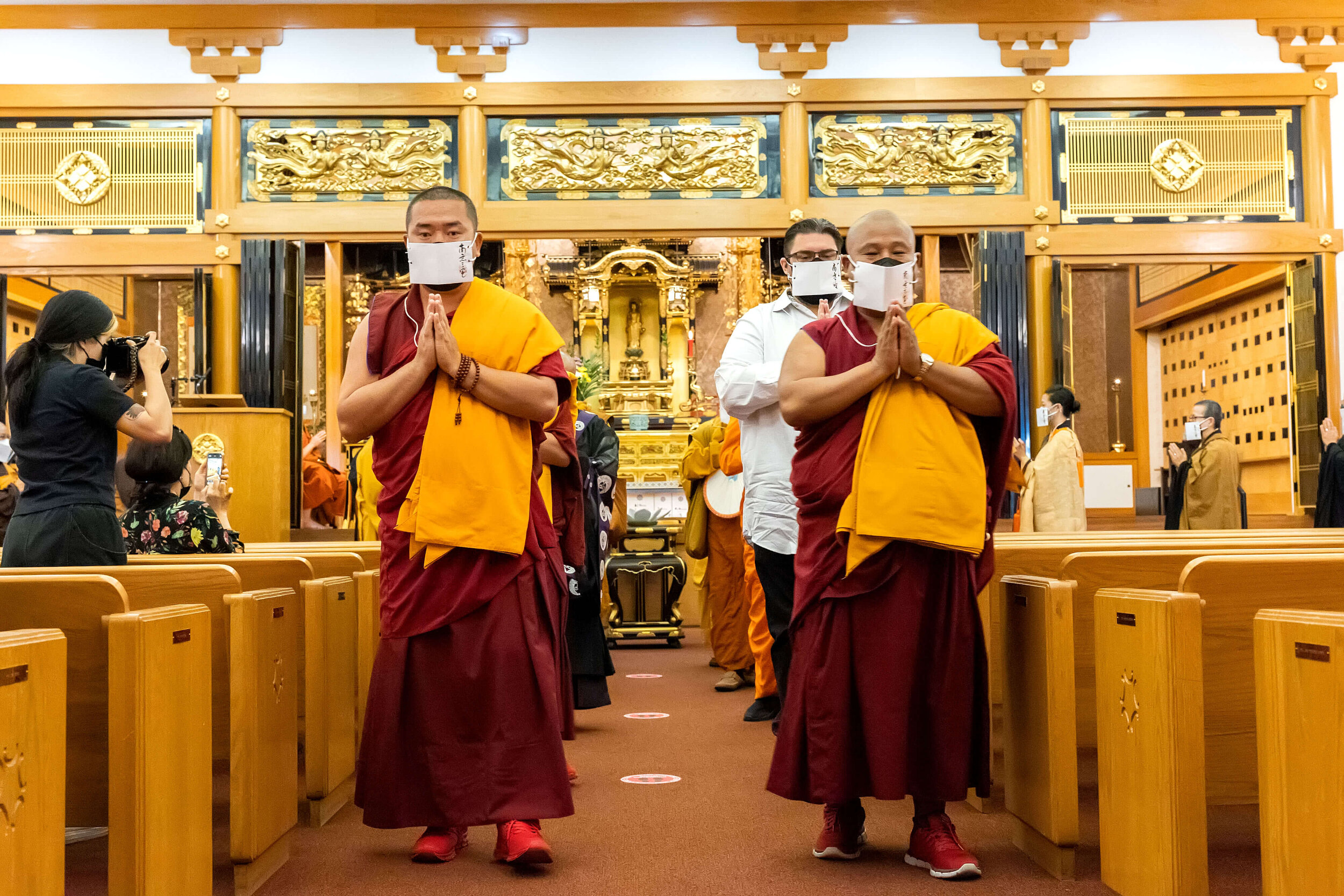 (left to right) Ven. Tenzin Lekshey and Geshe Phuntsho, lead the procession of Buddhist leaders, in pairs, out of the main hall