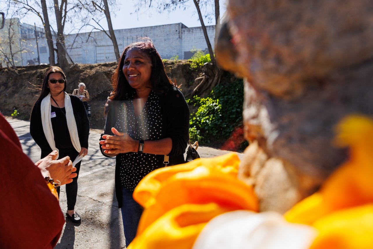 Antioch Mayor Pro-Tem Monica Wilson participates in the closing ritual at the Birthplace of Antioch Marker on F St with Tibetan chanting and khata scarf offerings.