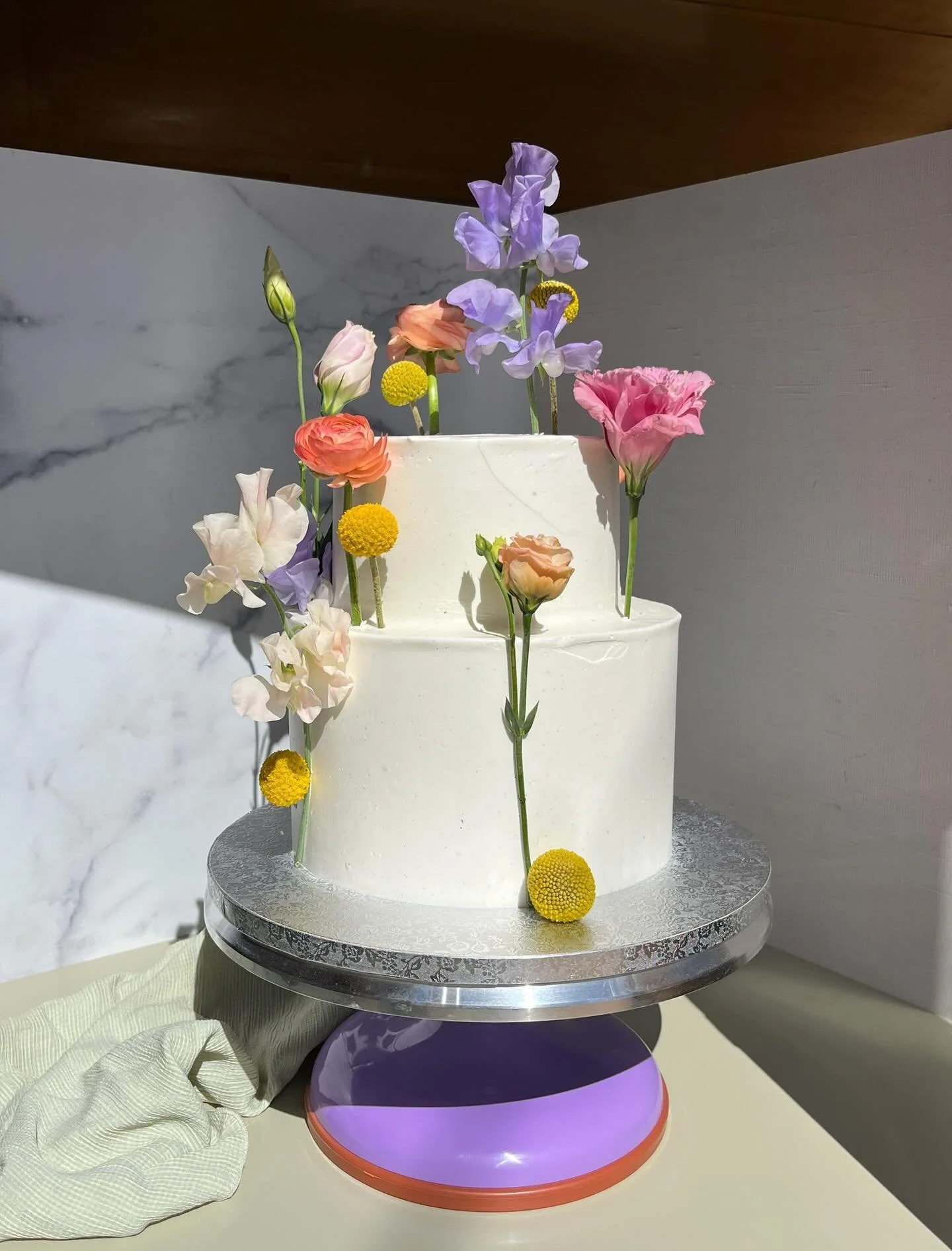 For Leila &amp; Will @sacredsandsjoshuatree 🩷💜💛🧡🤍💚

#lisianthus #rainbow #passionfruit #PICNICbakedgoods #pioneertown #petals #flowers #weddingcake #SMBC #baker #bakersofinstagram #layercake #tieredcake #cakedecorating #cottagebakery #wedding #