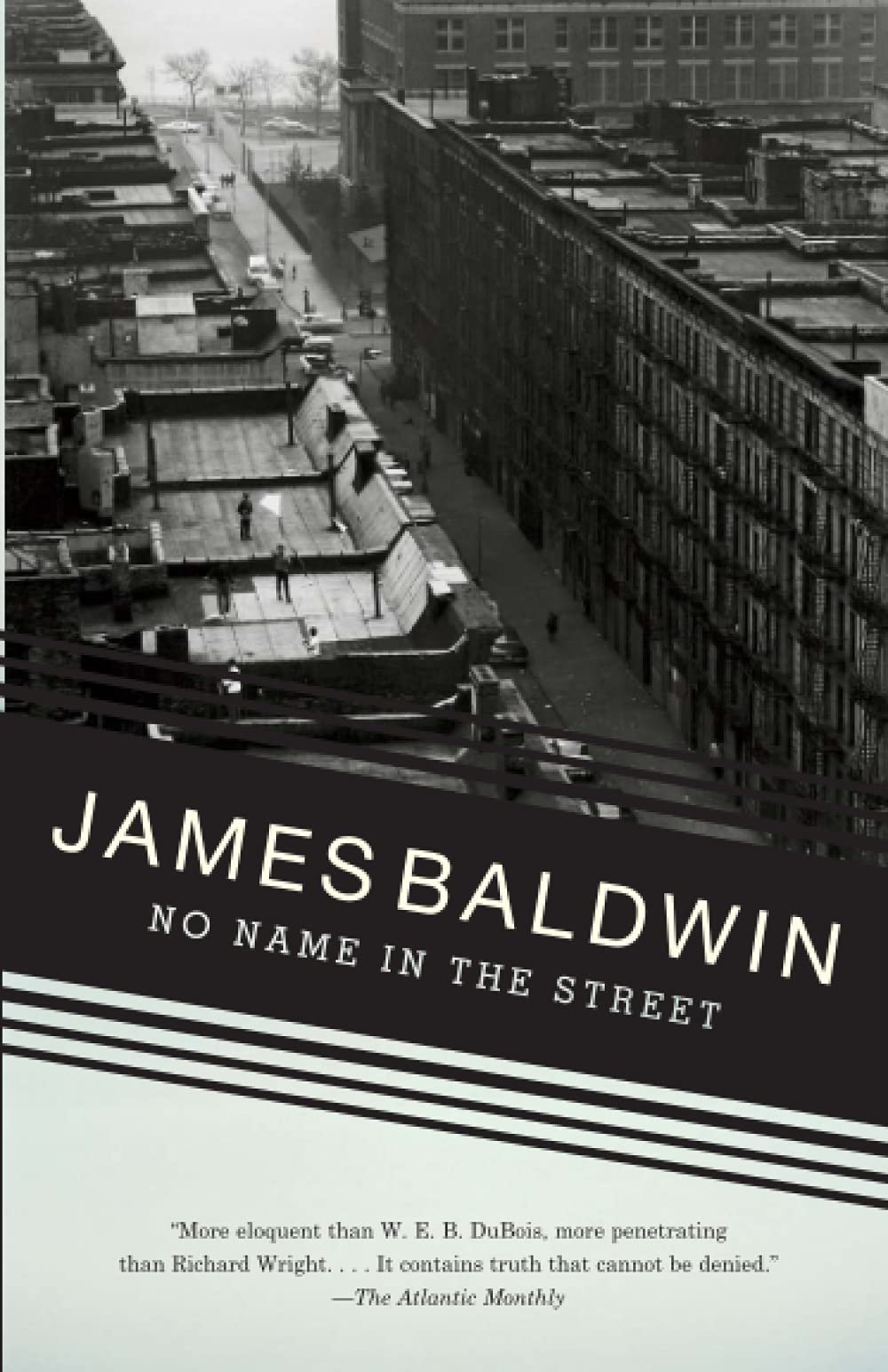 Cover of 'No Name in the Street' by James Baldwin featuring a black and white aerial view of an urban street with rows of buildings and pedestrians.