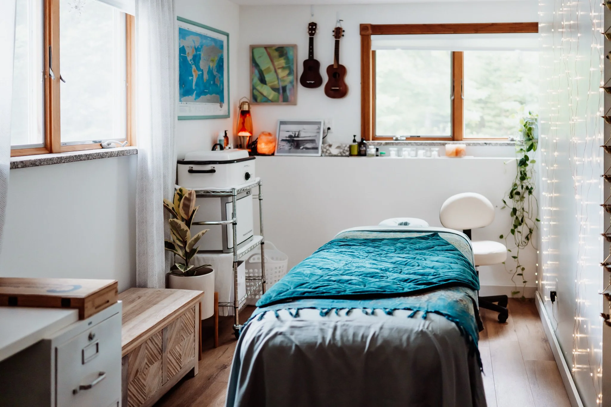 Serene therapeutic massage space designed with a coastal Maine aesthetic with natural light, soft textured linens, and décor inspired by nature's ocean blues and sandy neutrals