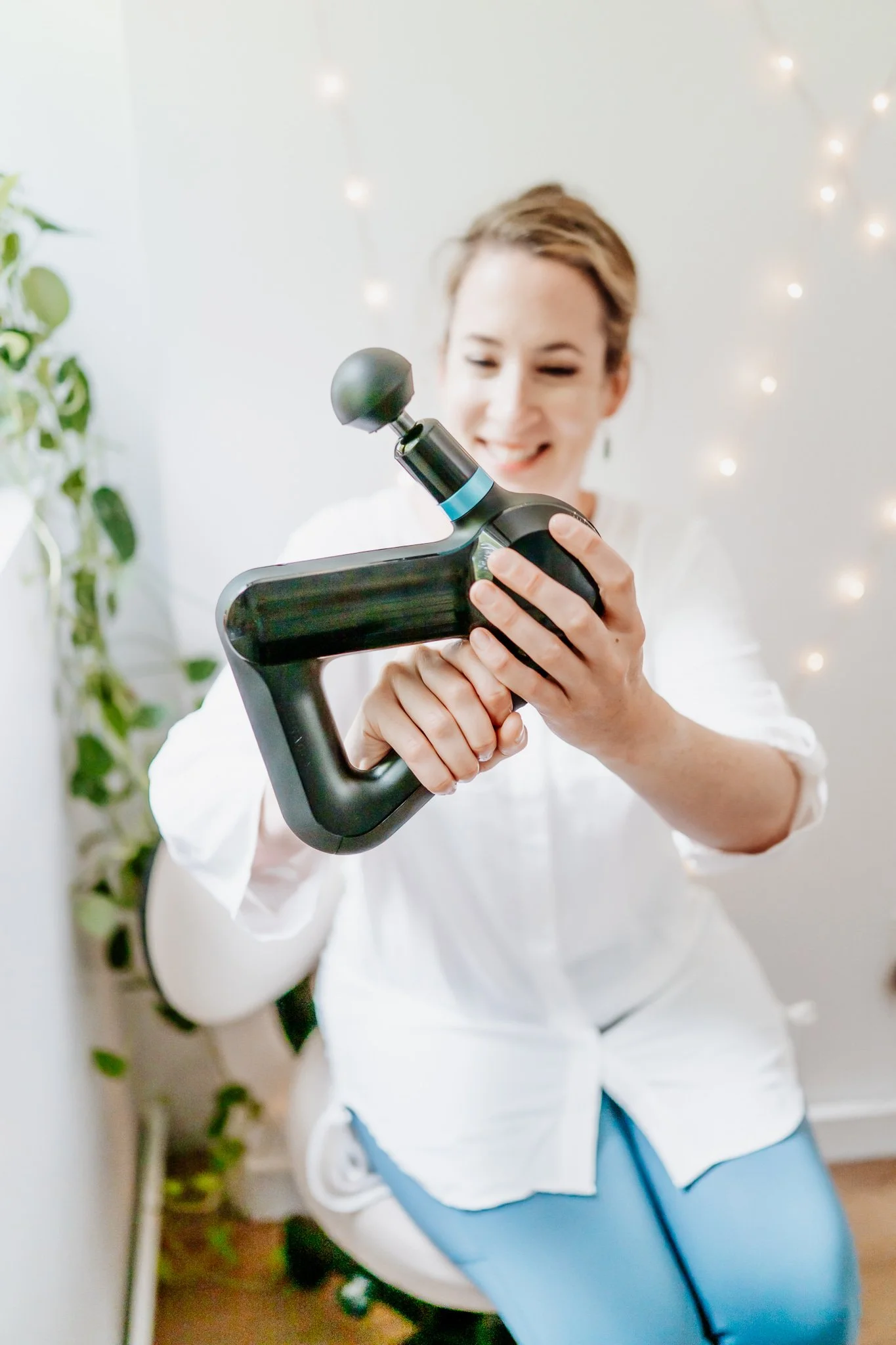 Massage therapist holding professional level Theragun percussion gun for percussion deep tissue and sports massage therapy