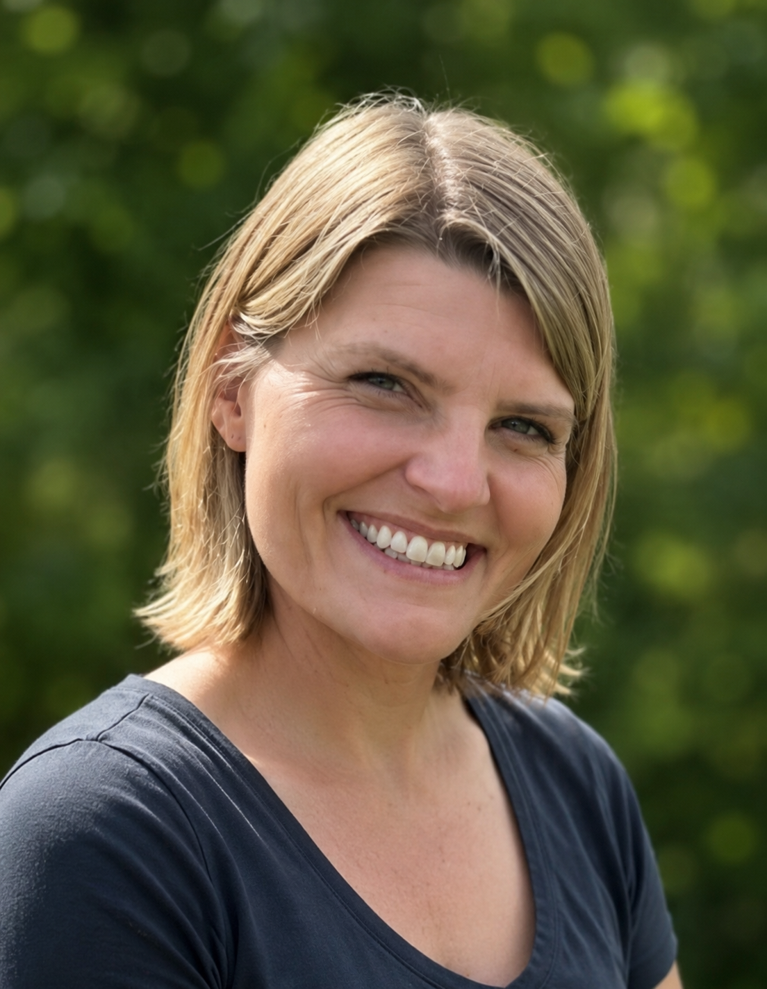 woman in grey shirt smiling 