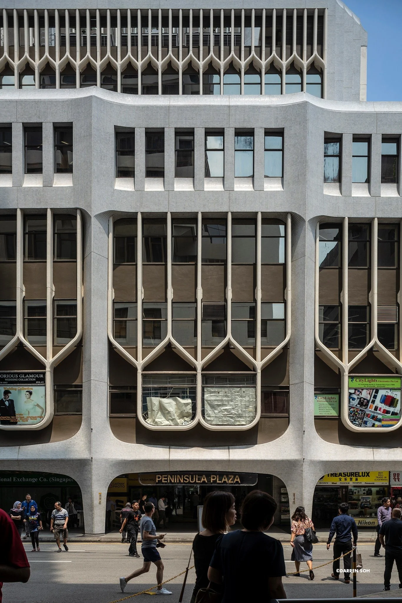 The concrete ribbing on the facade and its Gothic-inspired colums and arches. 