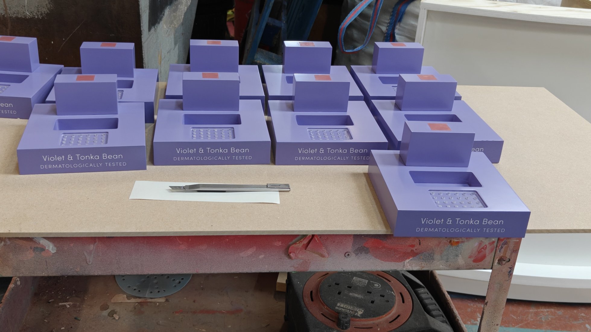 Spray finishing and vinyl branding to scenic components in Creator International's workshop