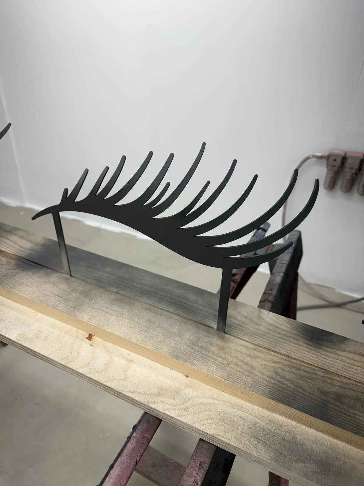 Spray finishing custom metalwork in the Creator International's workshop