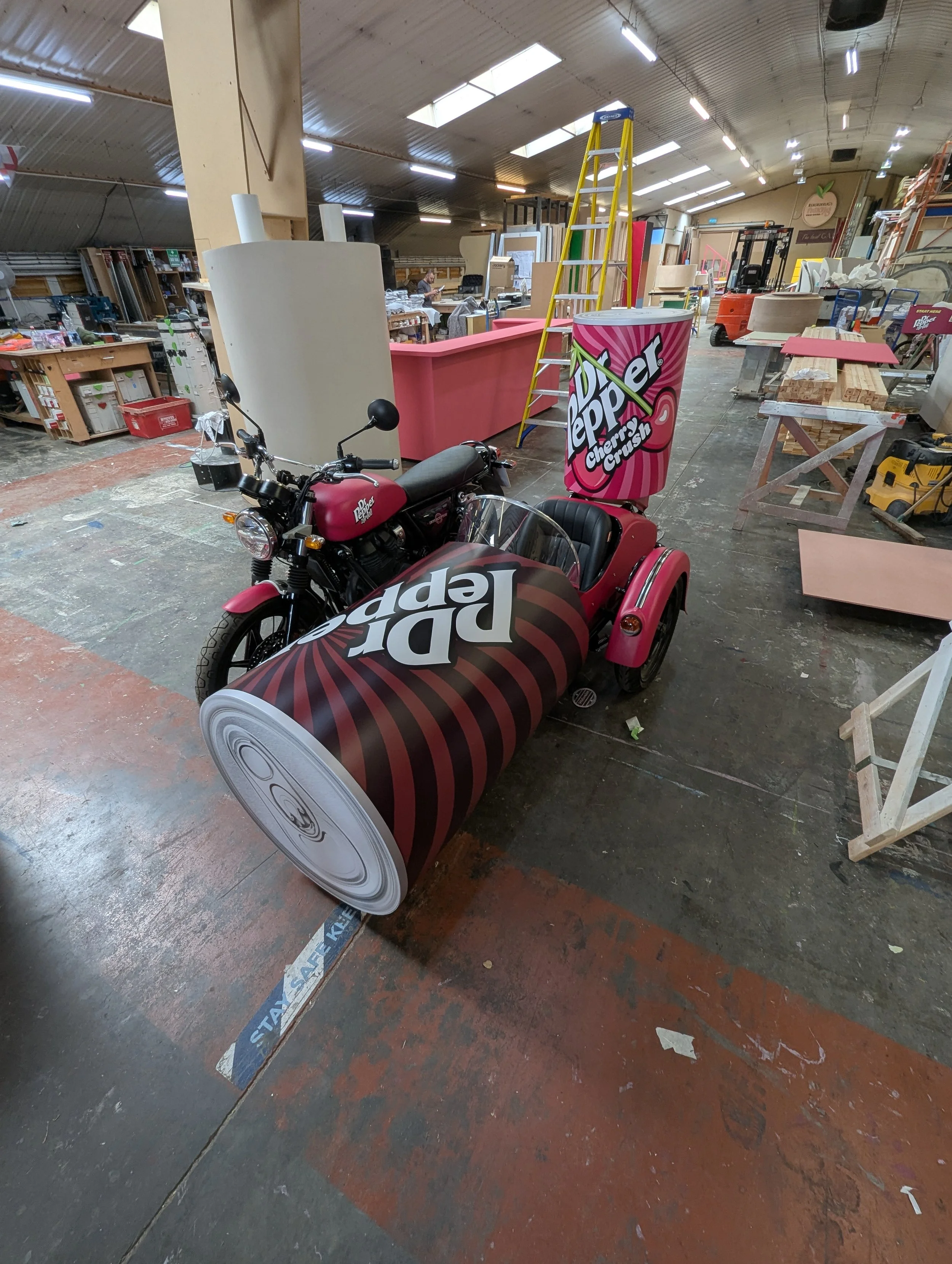 Custom promotional vehicle build and vinyl wrap at the Creator International workshop