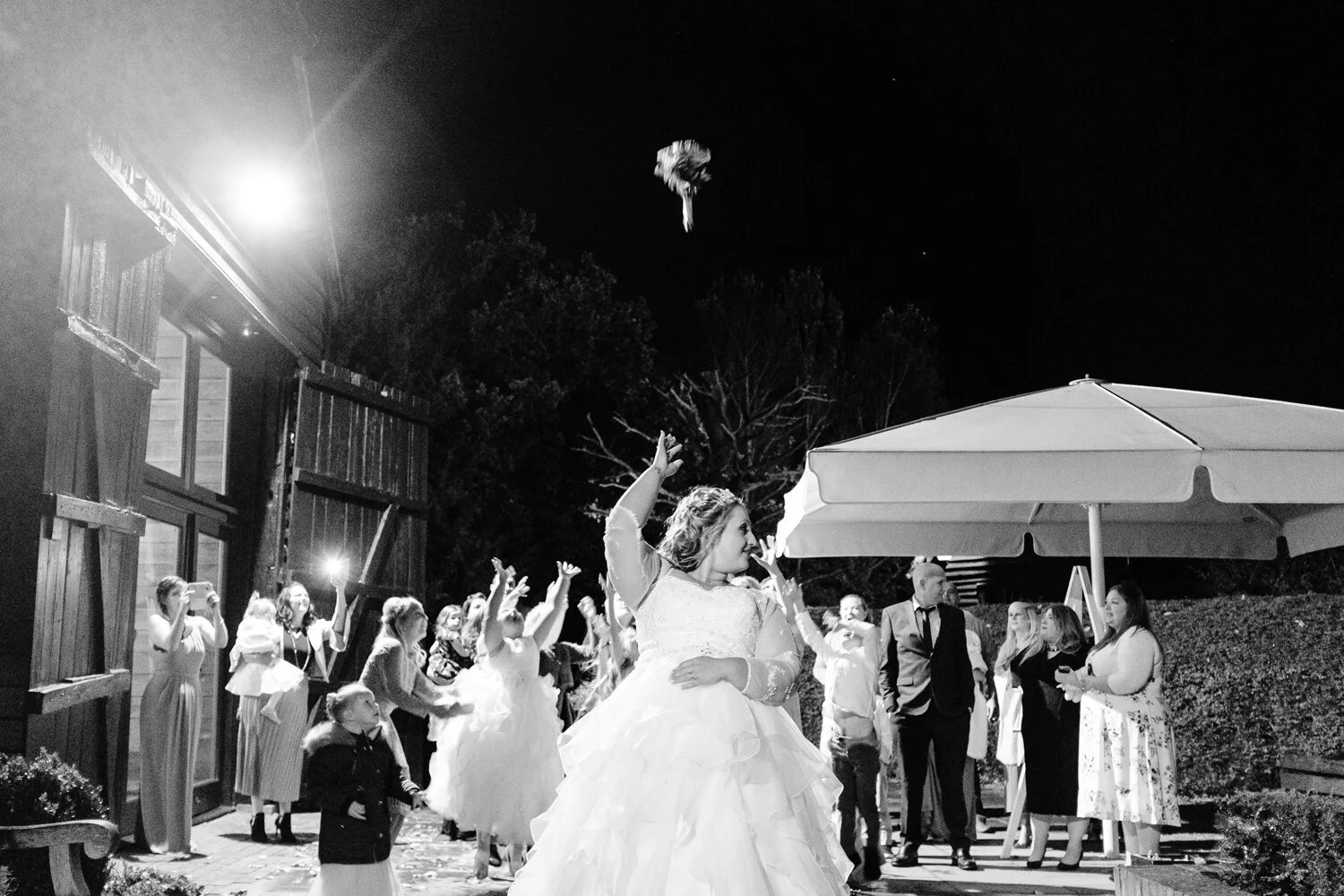 Bride throws her bouquet outside Surrey wedding venue