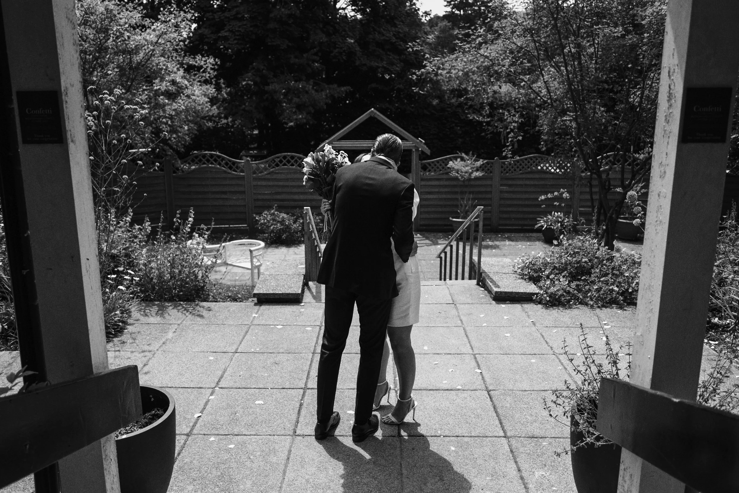 The newly married couple stand in the courtyard outside Guildford Register Office