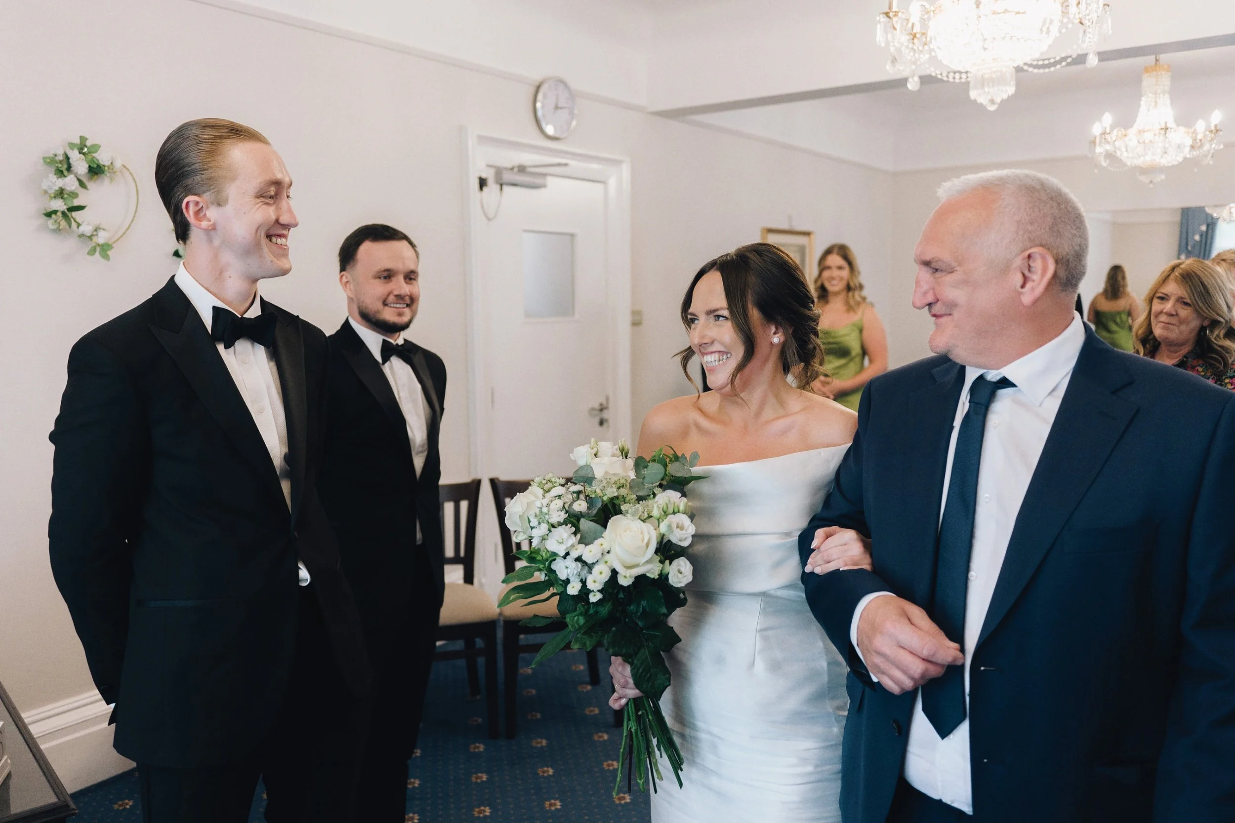 Father of the bride gives away the bride to the groom