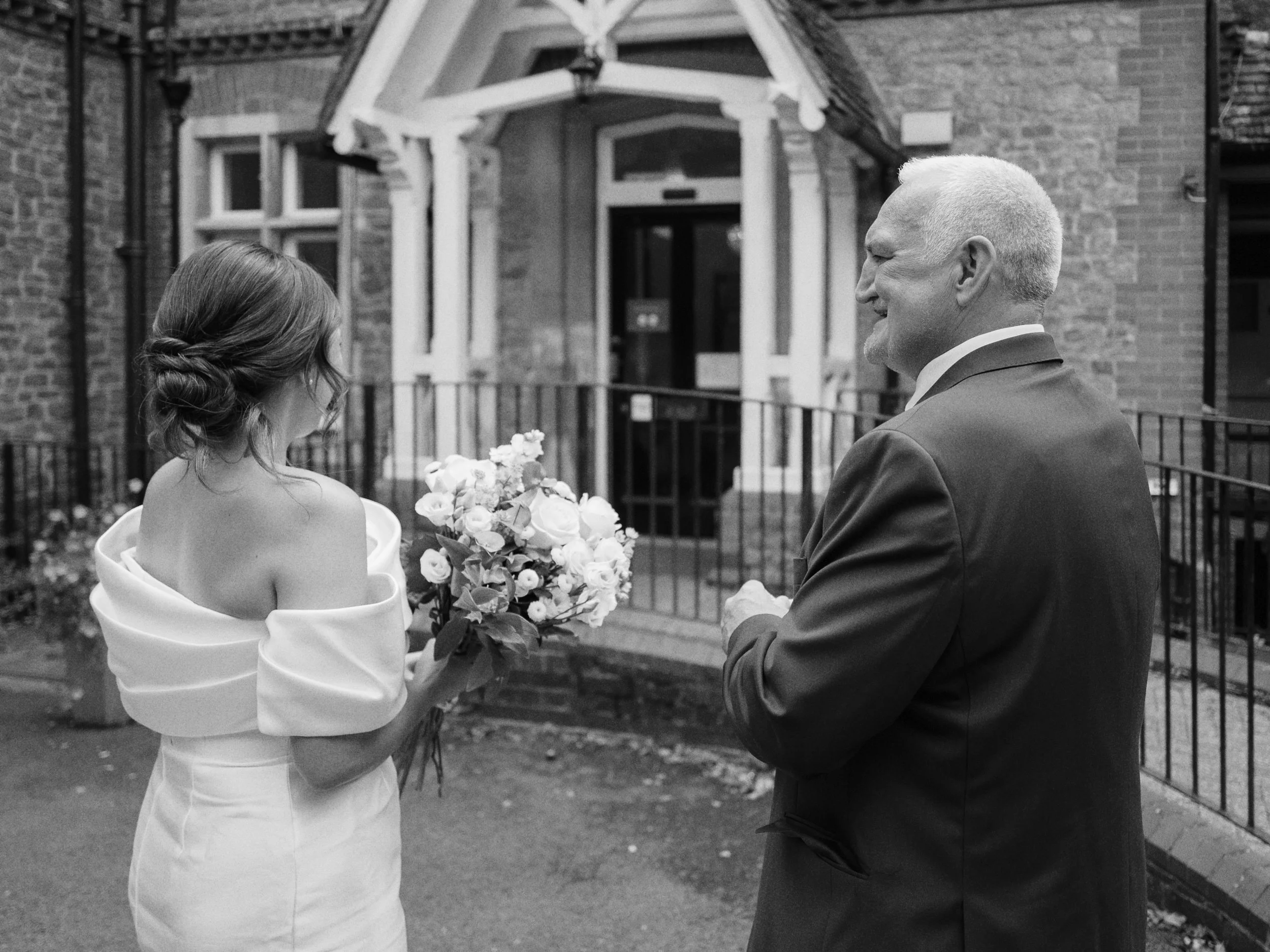 Bride and the father of the bride getting ready to walk into Guildford Register Office's ceremony room