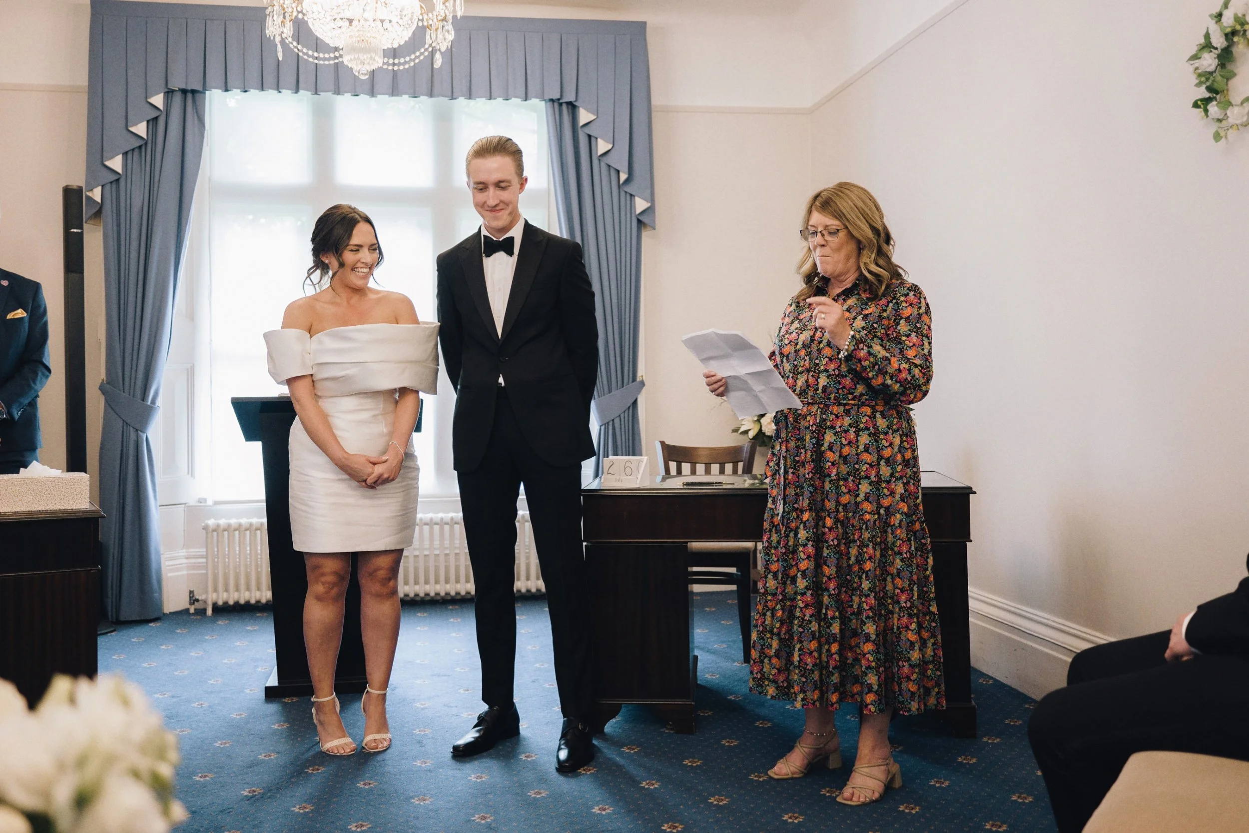 Bride and groom listen to the registrar at their wedding ceremony in Guildford