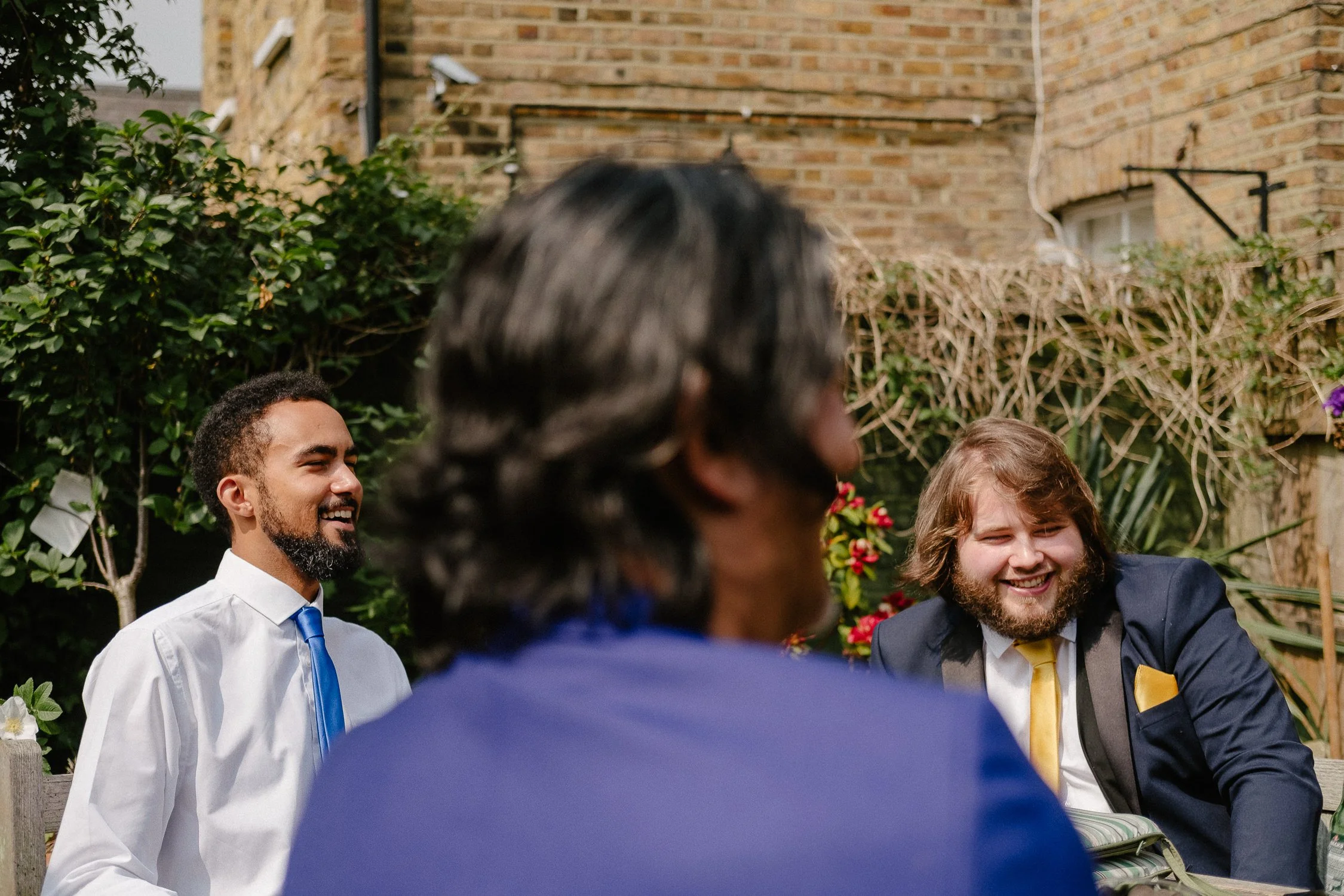 Wedding photographer Surrey UK captures groomsmen laughing on the wedding day